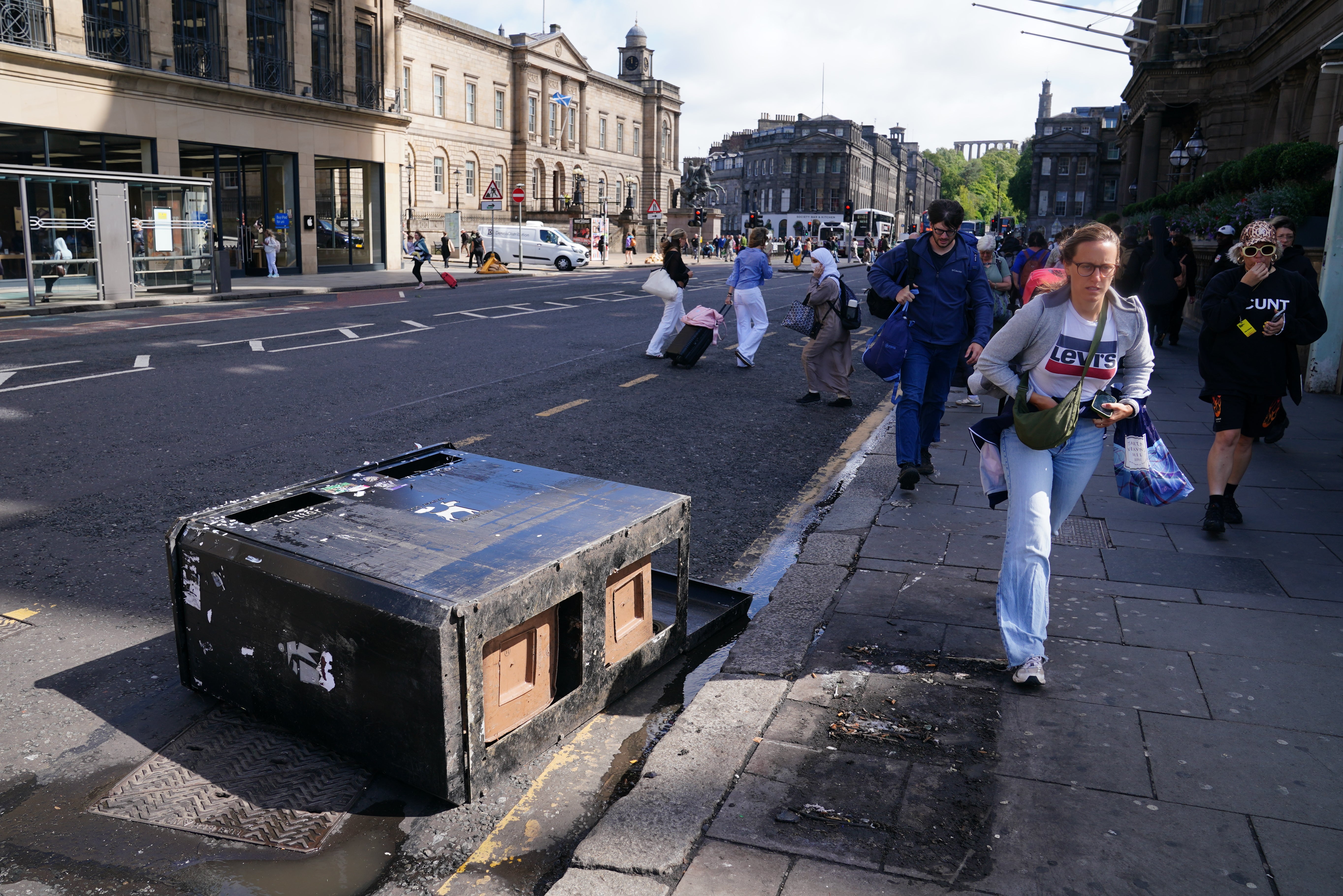 A bin bears the brunt of the strong winds on Princes Street in Edinburgh (Jane Barlow/PA)