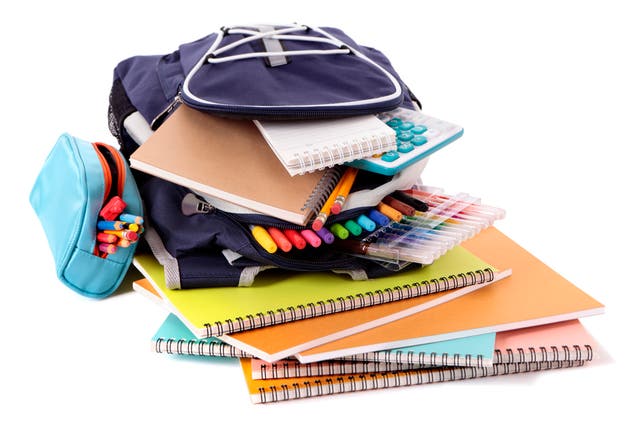 <p>Blue backpack overflowing with various school supplies</p>
