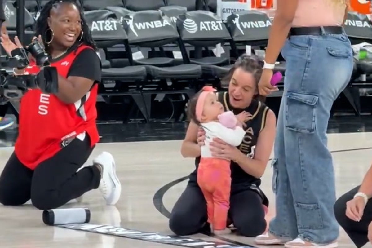 Baby takes first steps during crawling race at WNBA half time show