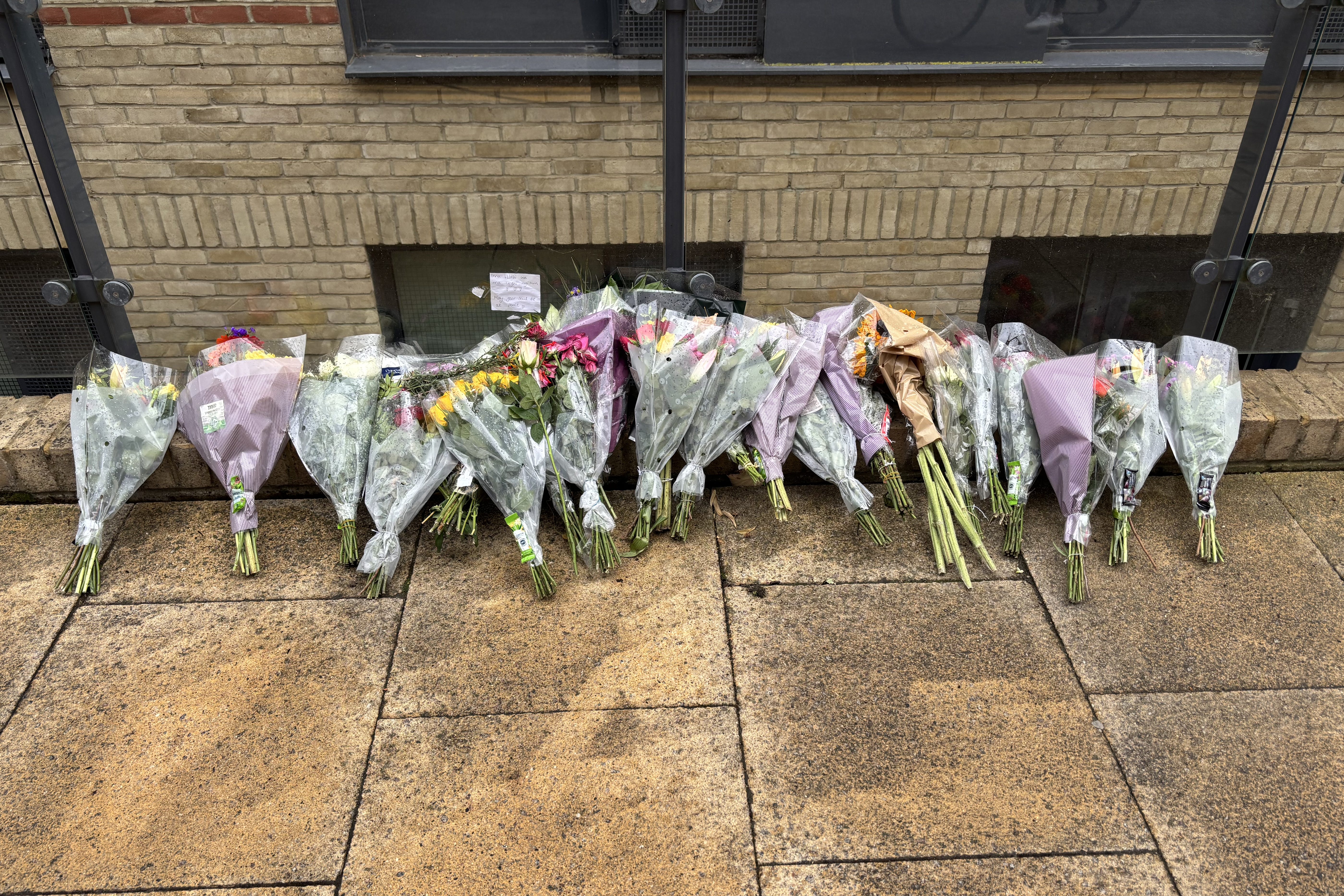 Floral tributes left outside a building in Mill Park, Cambridge, on the road where 20-year-old student Mohammed Algasim was fatally attacked (Sam Russell/PA)
