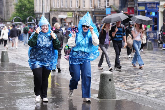 Members of the public battle against the weather as they walk along the Royal Mile, Edinburgh (Jane Barlow/PA)