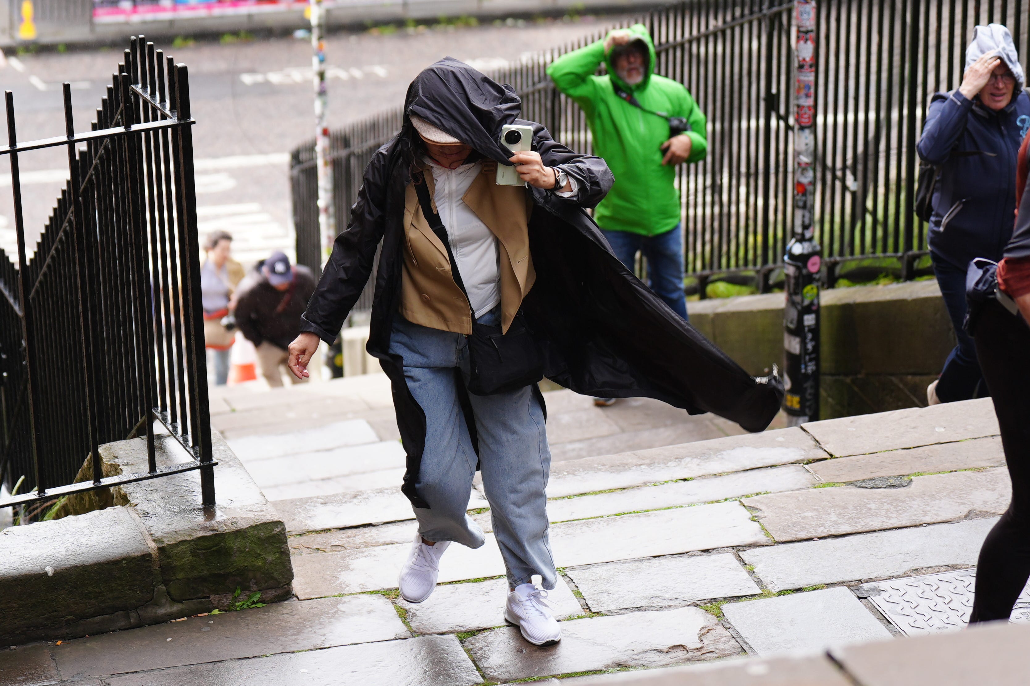 Members of the public battle against the wind as they walk along the Royal Mile in Edinburgh (Jane Barlow/PA)