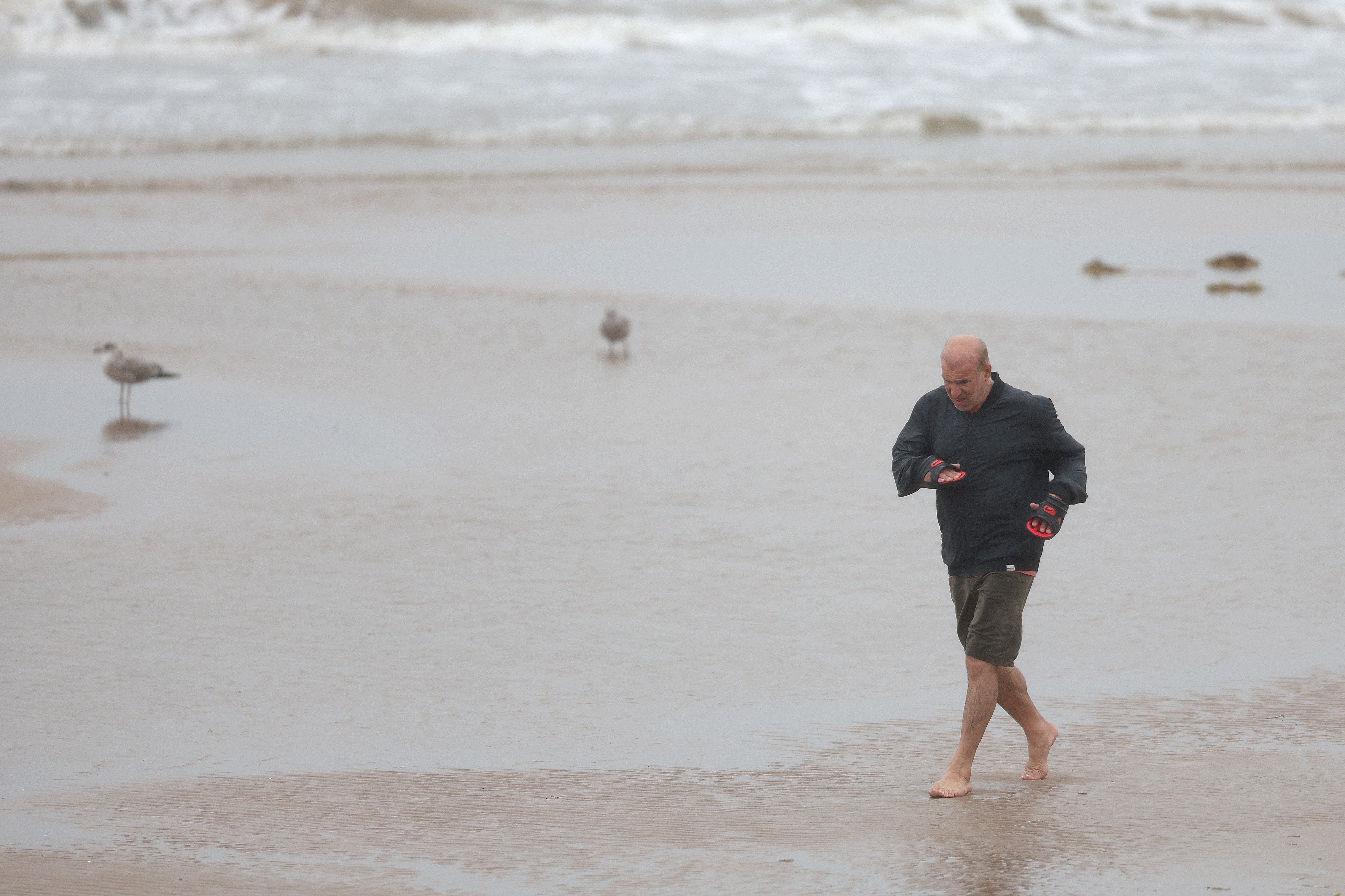 <p>A man braves the weather as he runs down the Blackpool Promenade on August 04, 2025 in Blackpool, England</p>