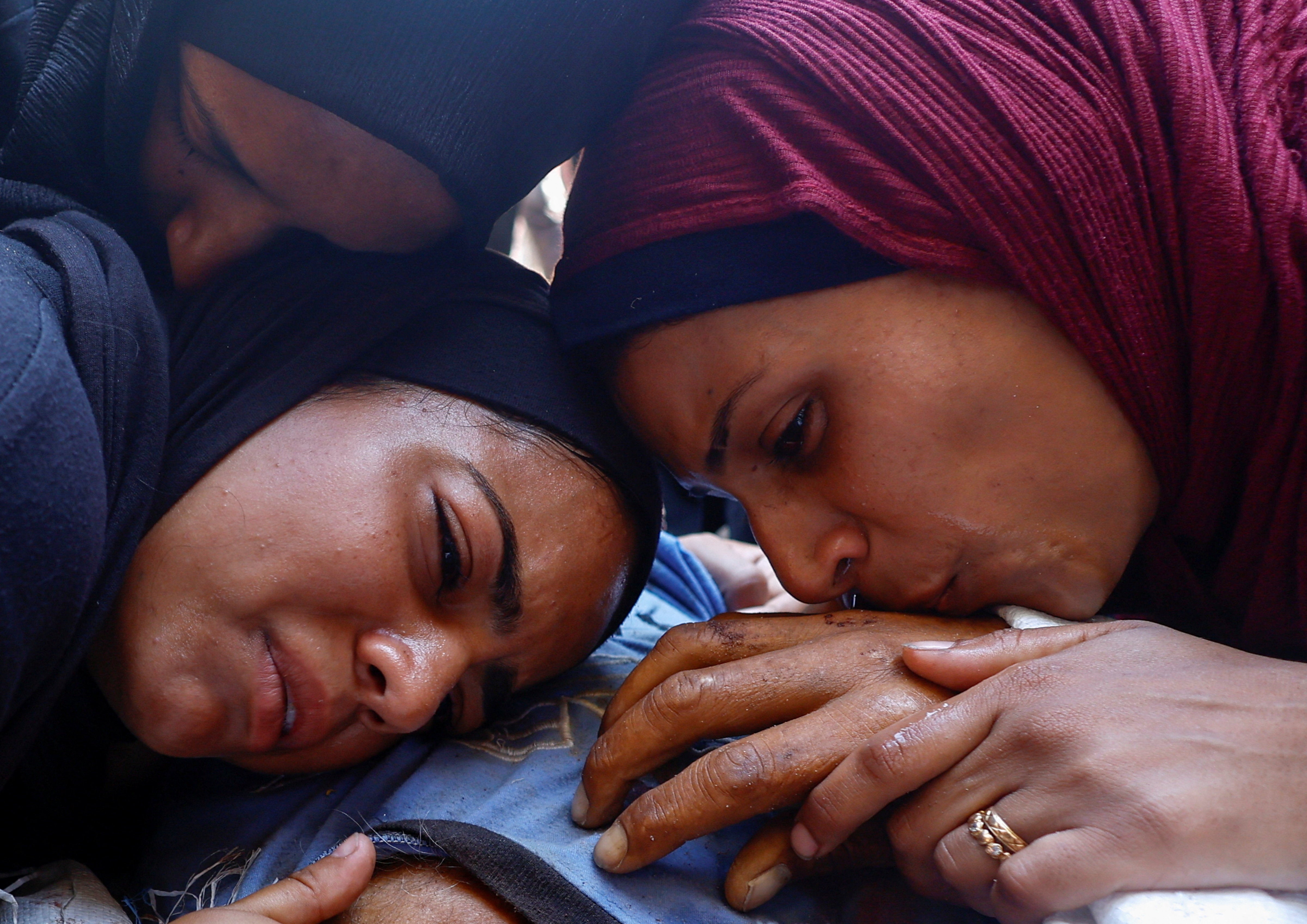 People mourn during the funeral of Palestinian aid seekers who were killed by Israeli fire