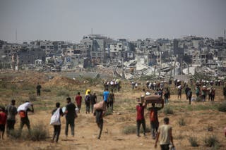 Palestinians carry aid supplies