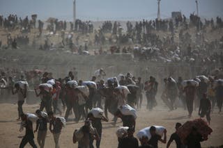 Palestinians carry aid supplies