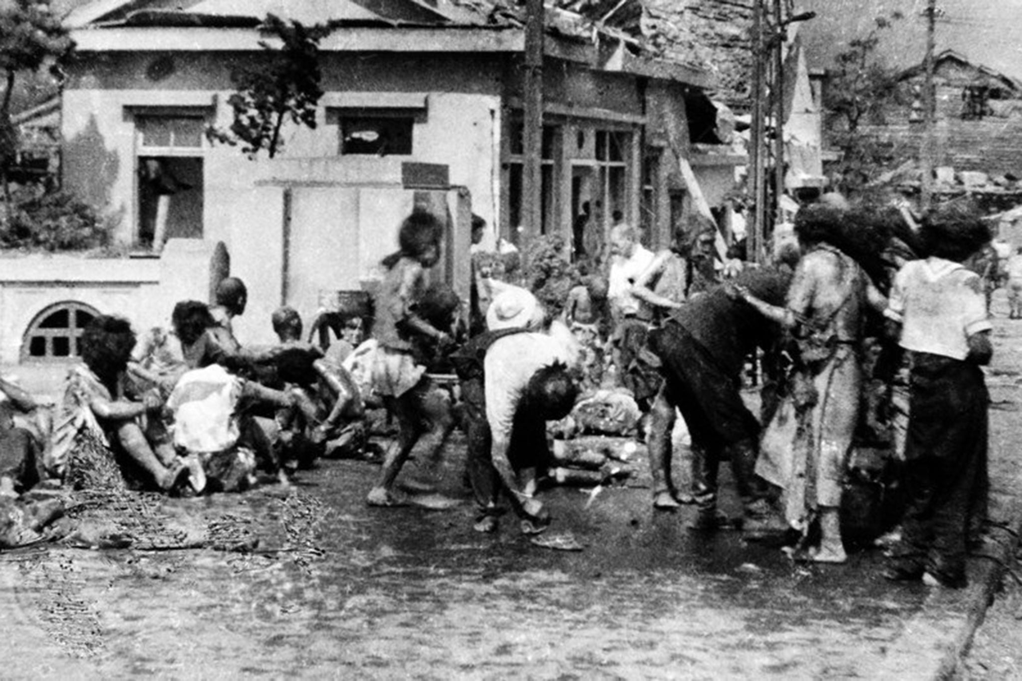 People injured in the Hiroshima bombing gather on a bridge