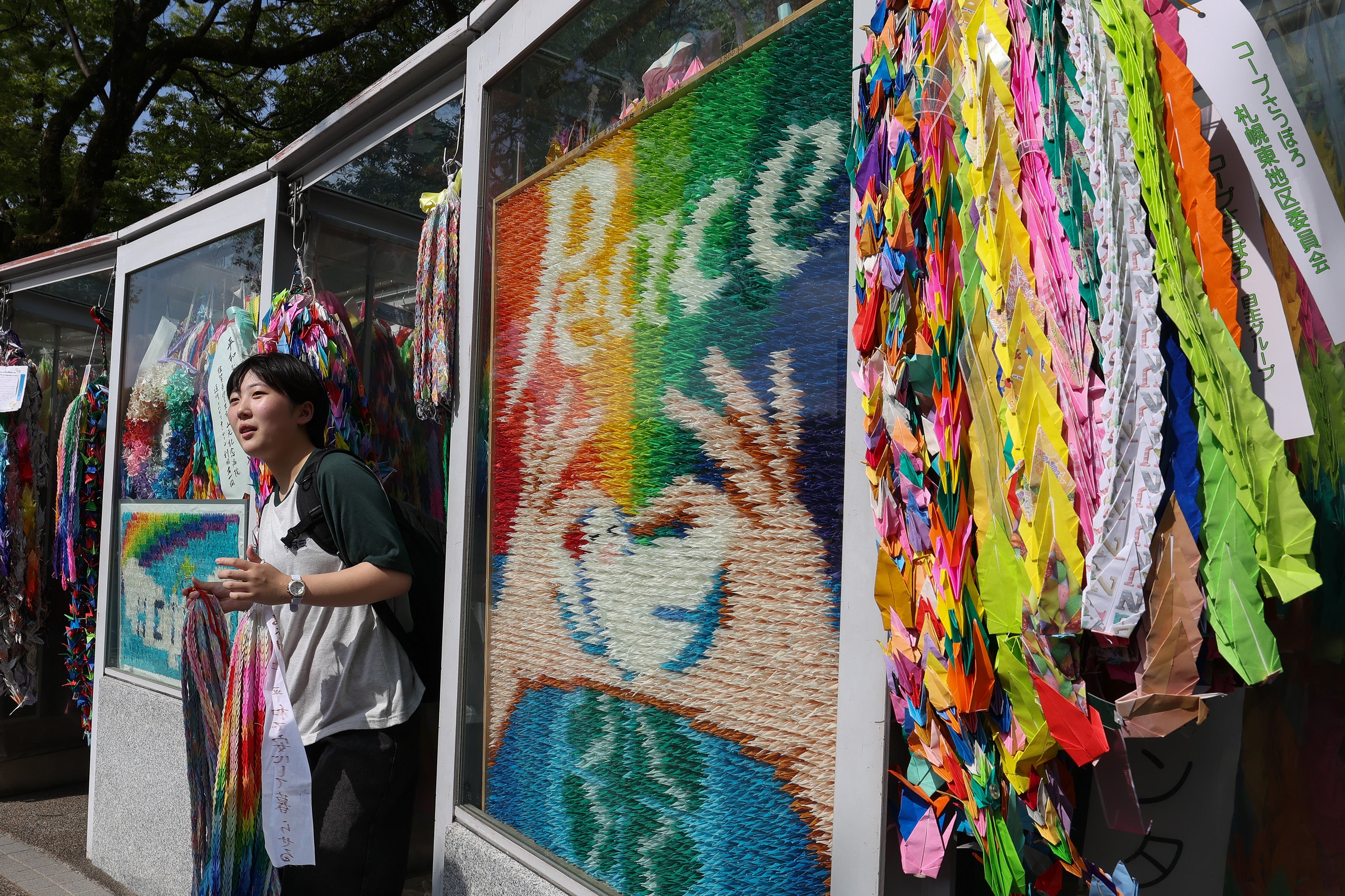 A young girl visits the Children's Peace Monument ahead of the 80th anniversary of the atomic bomb dropped on Hiroshima at the Hiroshima Peace Memorial Park on 5 August 2025 in Hiroshima, Japan