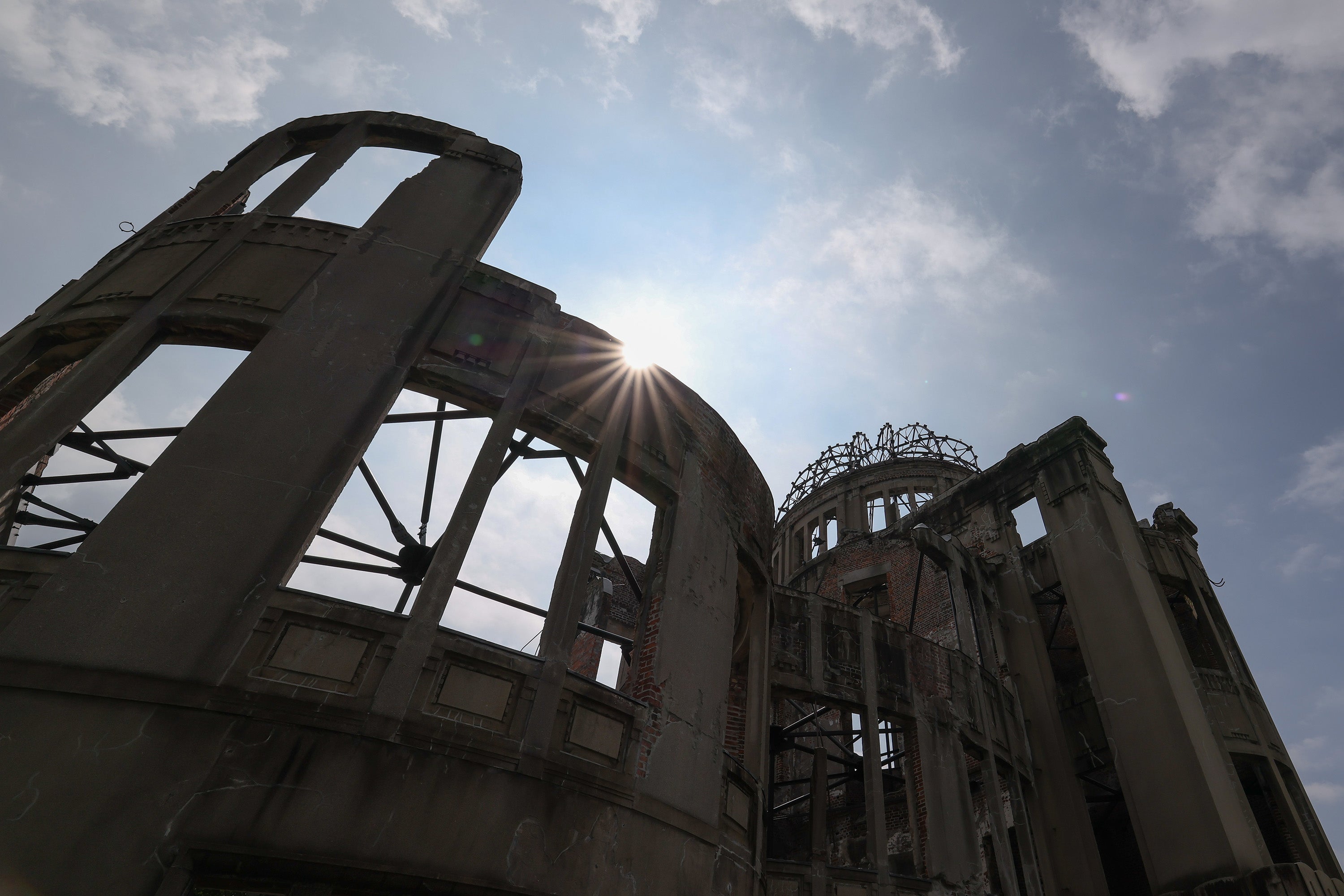 The sun rises above the Atomic Bomb Dome ahead of the 80th anniversary of the atomic bomb dropped on Hiroshima at the Hiroshima Peace Memorial Park on 5 August 2025 in Hiroshima, Japan