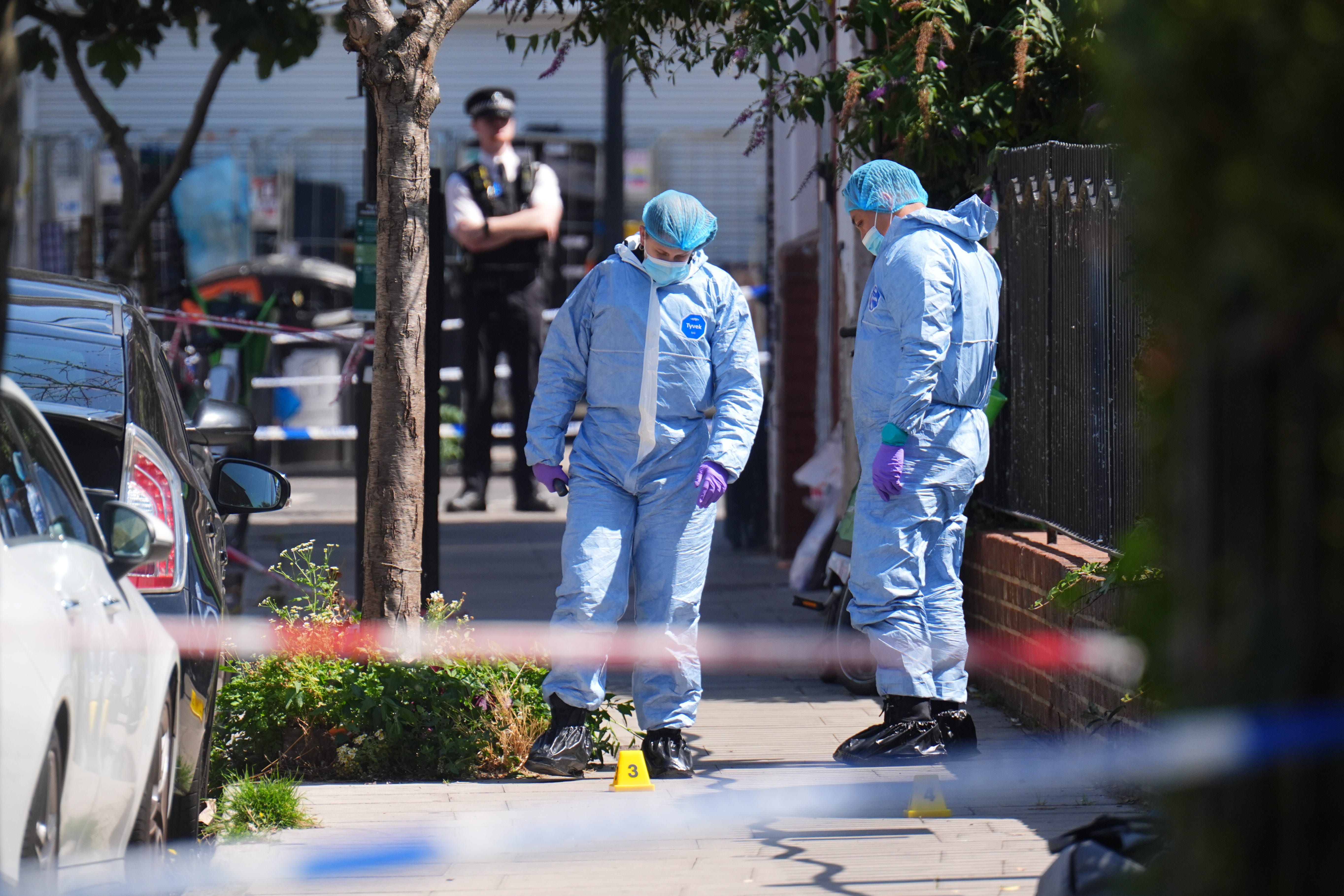 Forensic police officers at the scene at Dynevor Road, Stoke Newington, after a 45-year-old man has been shot dead in north London (James Manning/PA)