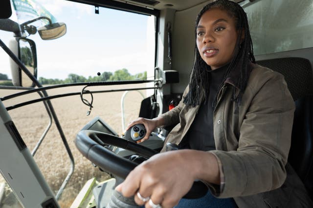 Kemi Badenoch sits in the cab of a combine harvester during her visit to Hall Farm in Little Walden, Essex (Stefan Rousseau/PA)