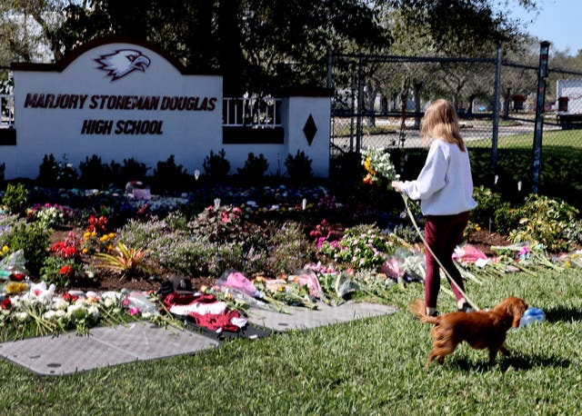Memorial in front of Marjory Stoneman Douglas High School to honor those killed during a mass shooting ( Getty Images )