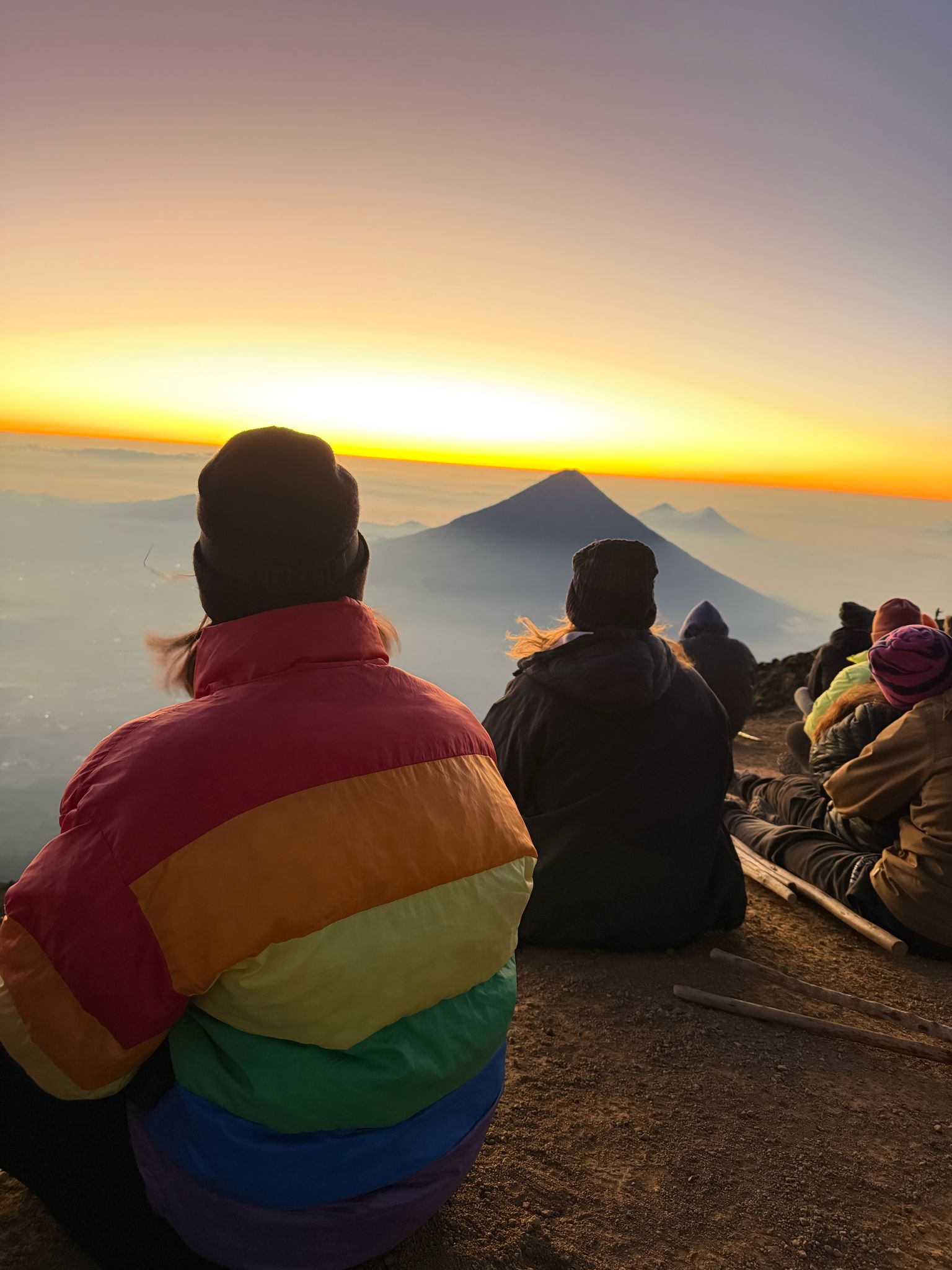 Climbers watch the sunrise over Fuego