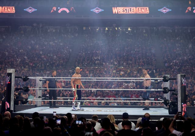 <p>Cody Rhodes and John Cena (R) listen to the crowd at the start of their Undisputed WWE Championship match during WrestleMania 41 at Allegiant Stadiu</p>