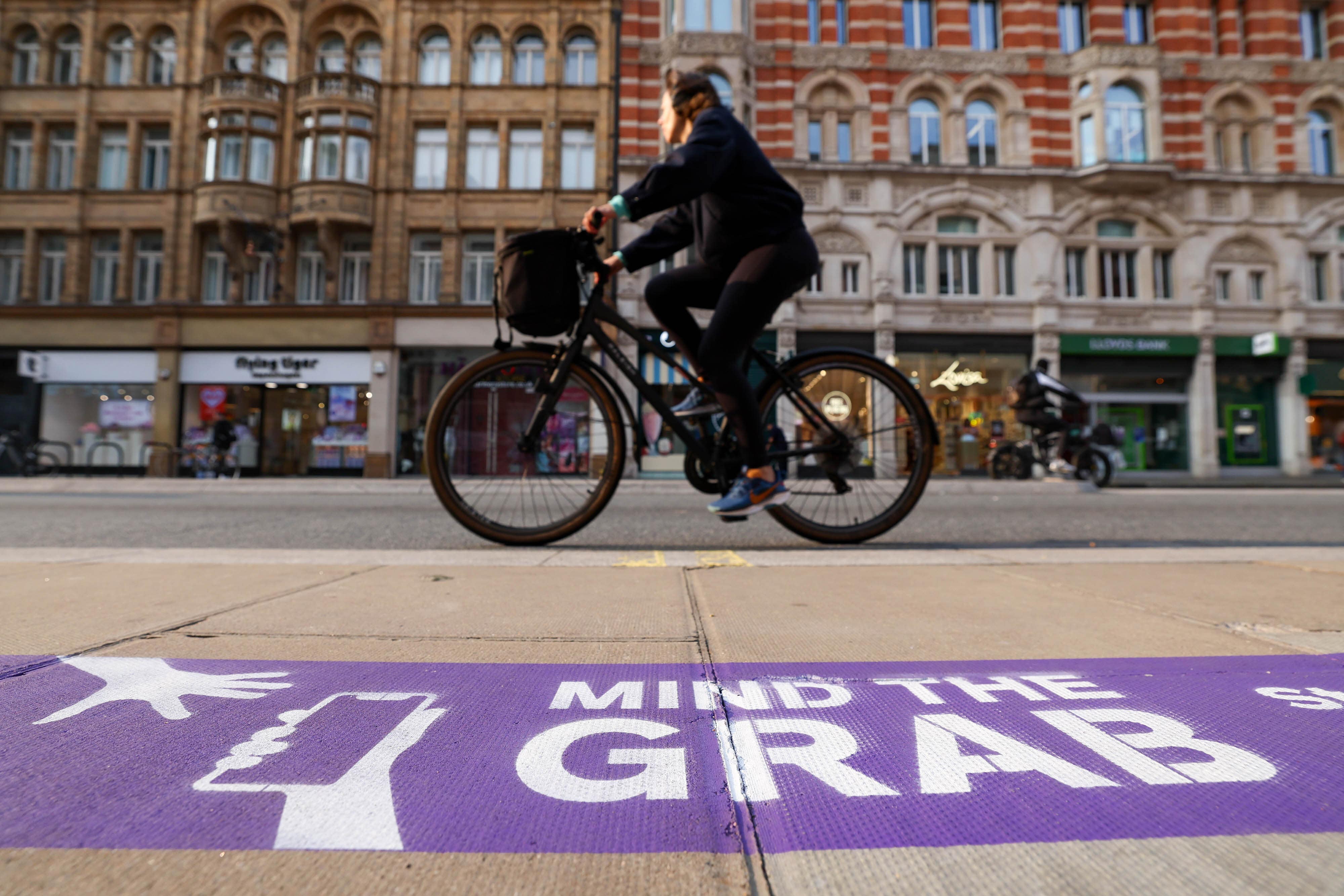 <p>The purple line outside Currys in London’s Oxford Street in London is part of the retailer’s ‘Mind the Grab’ campaign </p>
