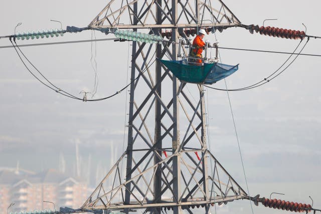 Engineers work on power lines (Chris Ison/PA)