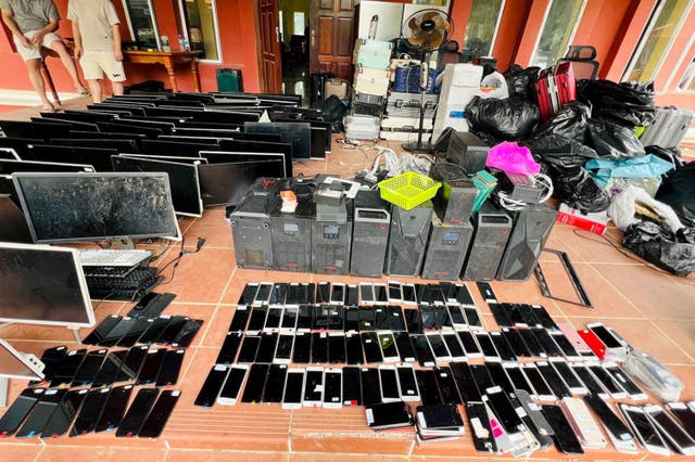 <p>File. Computers, phones and other equipment seized during a raid on a scam centre in Kandal province of Cambodia</p>