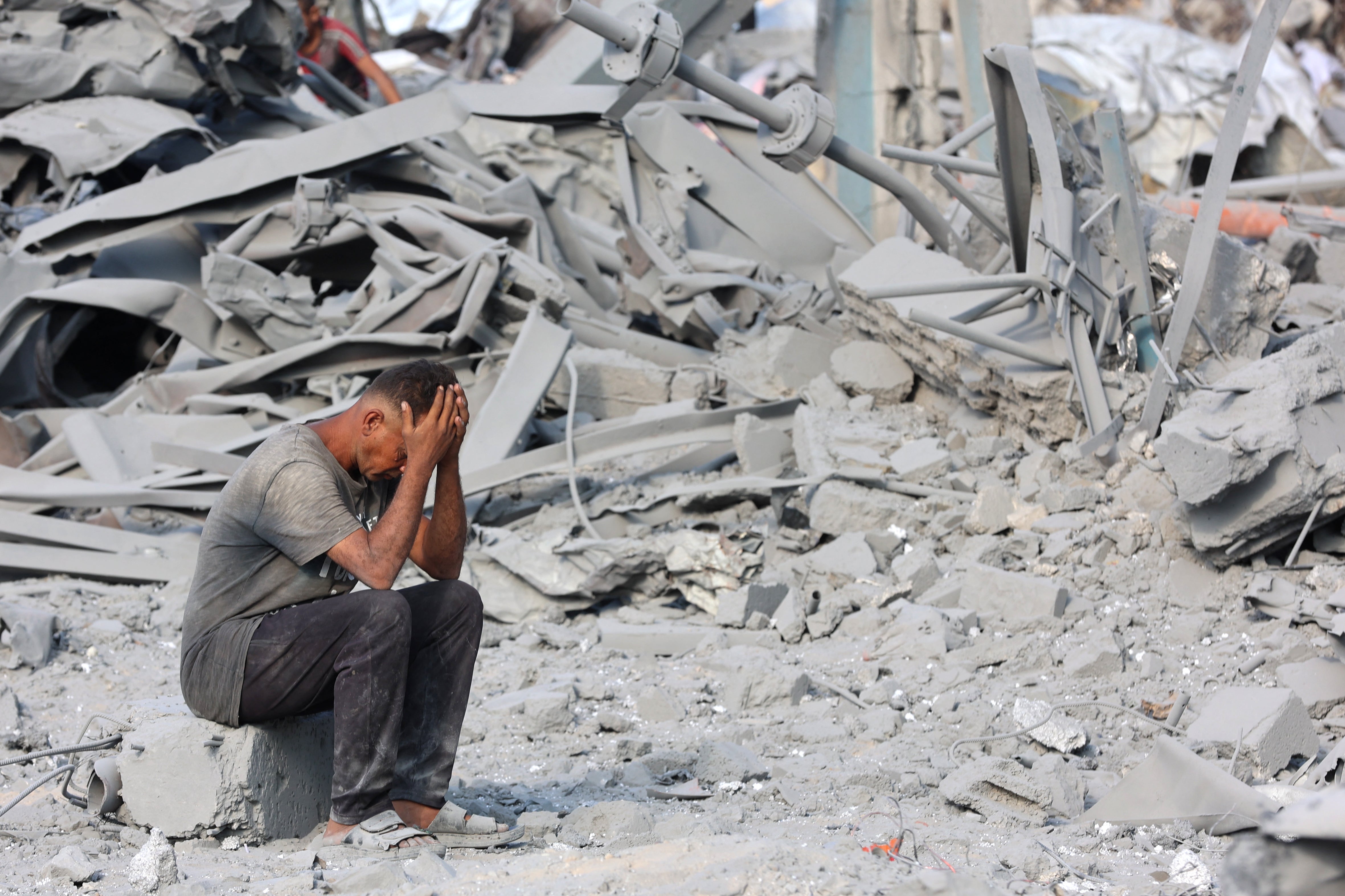 A Palestinian man reacts to the destruction after an overnight strike on the Sheikh Radwan Health Centre in the north of Gaza City on August 6, 2025
