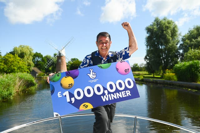 <p>Paul Harvey, 51, from Attleborough, Norfolk celebrates his £1 million lottery win</p>