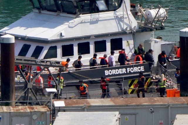 <p>A group of people thought to be migrants are brought in to the Border Force compound in Dover, Kent, from a Border Force vessel </p>