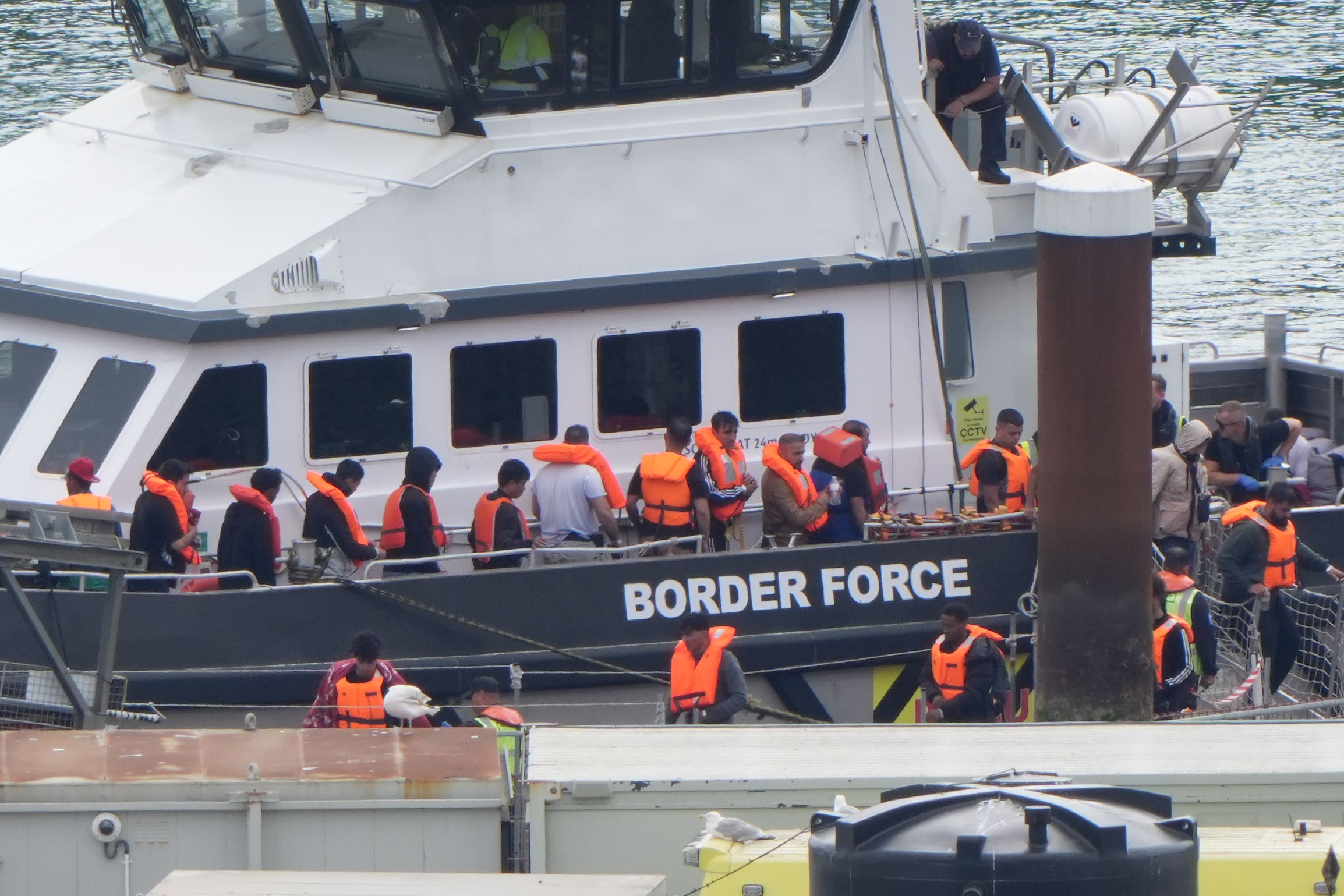 A group of people thought to be migrants are brought in to Dover, Kent, from a Border Force vessel (PA)