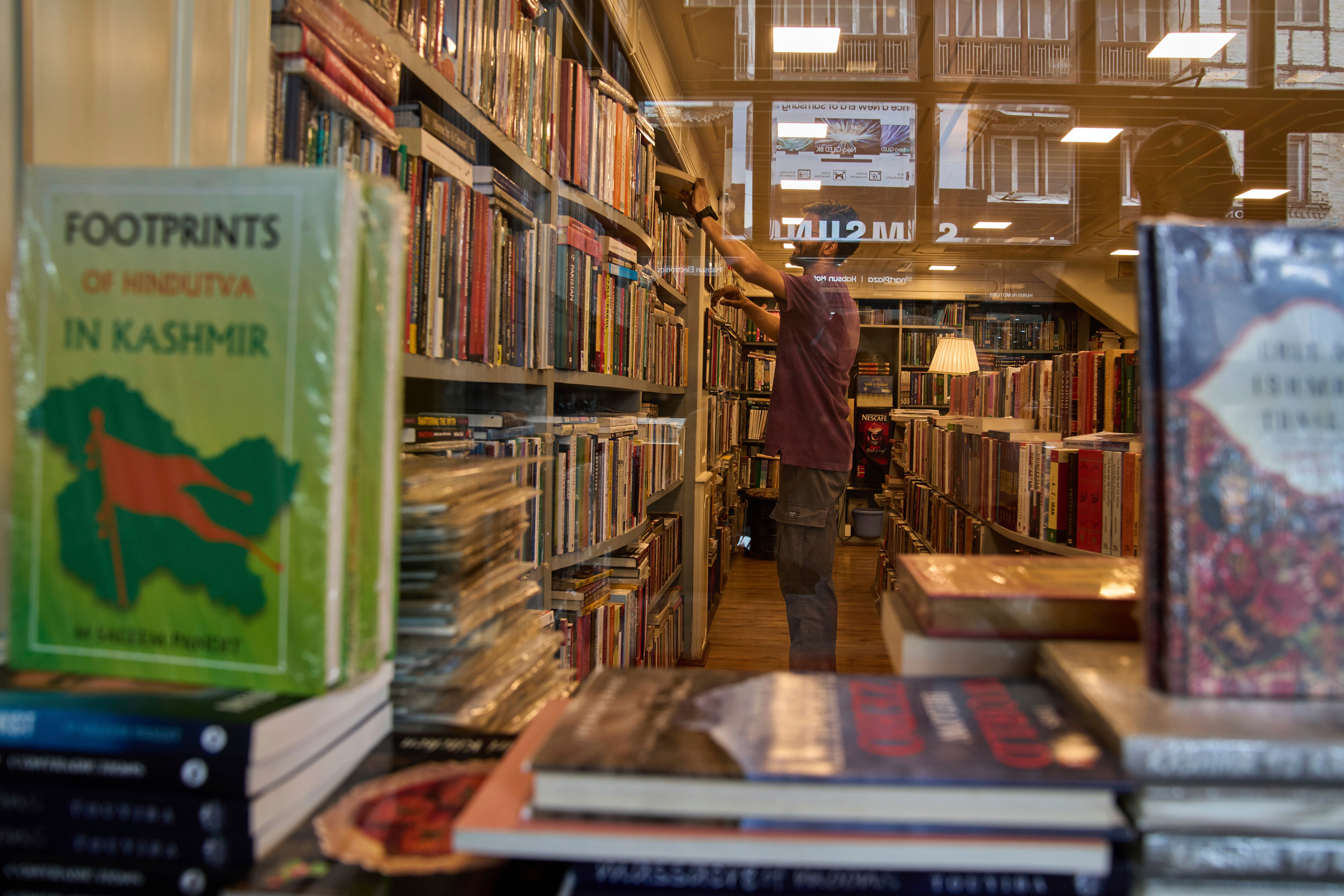 A man looks at a book inside a bookstore in Srinagar, Kashmir, in 2025 (AP)