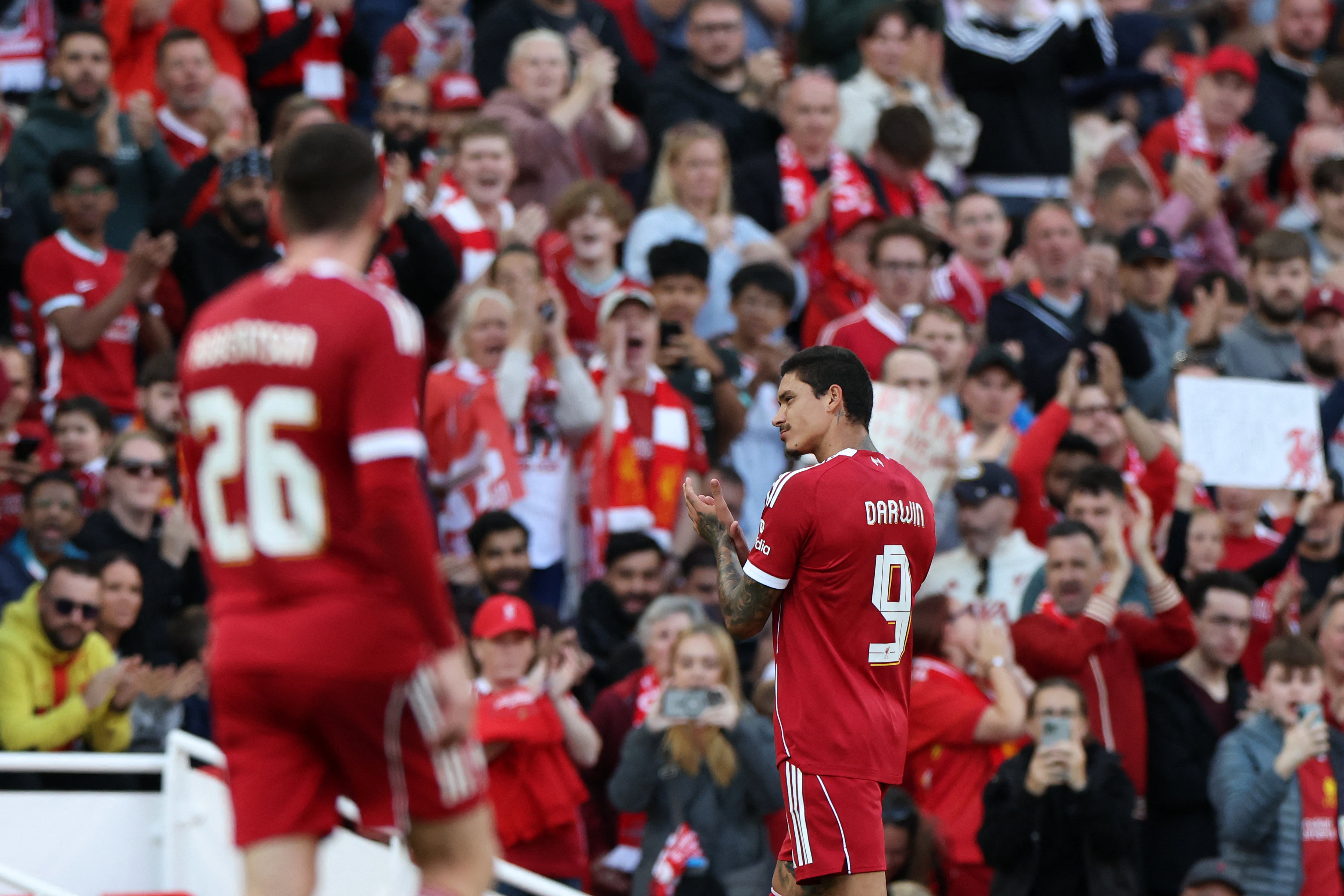 Darwin Nunez applauds Liverpool fans as he leaves the Anfield pitch for the last time