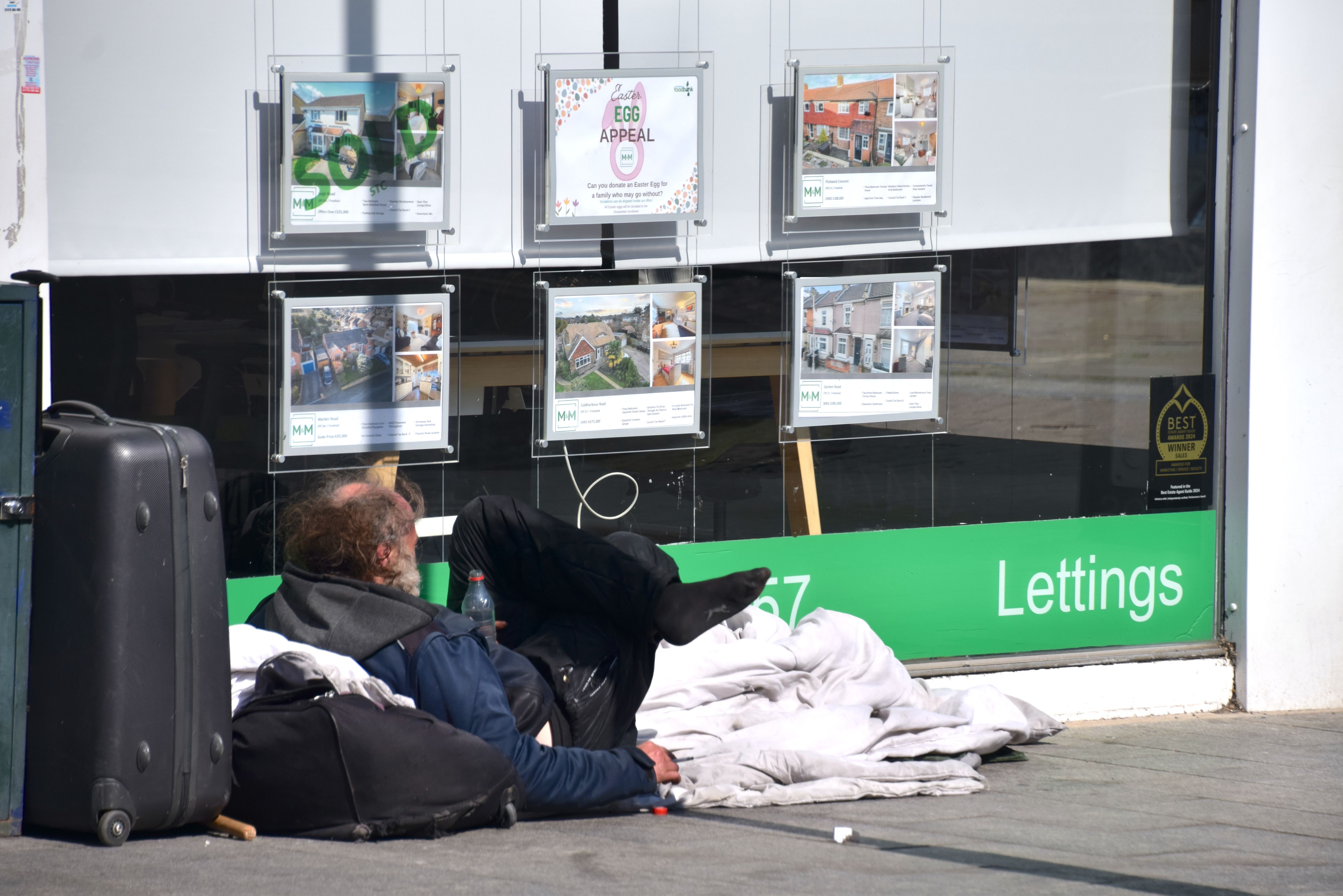 A homeless person outside a lettings agent in Gravesend, Kent