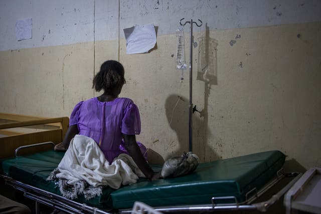 <p>A woman waits for a doctor visit at the emergency ward of the Maiani General Hospital in Ethiopia</p>