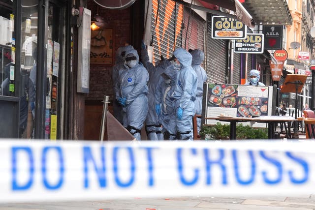Police forensic officers at the scene of a shooting at Kingsland High Street, Hackney, east London, where three adults and a child have been injured. The Metropolitan Police have said the child is in a serious condition and that they are awaiting updates on the condition of the adults. Police said they were called to the scene at around 9.20pm on Wednesday with specialist firearms officers attending. Picture date: Friday May 31, 2024.