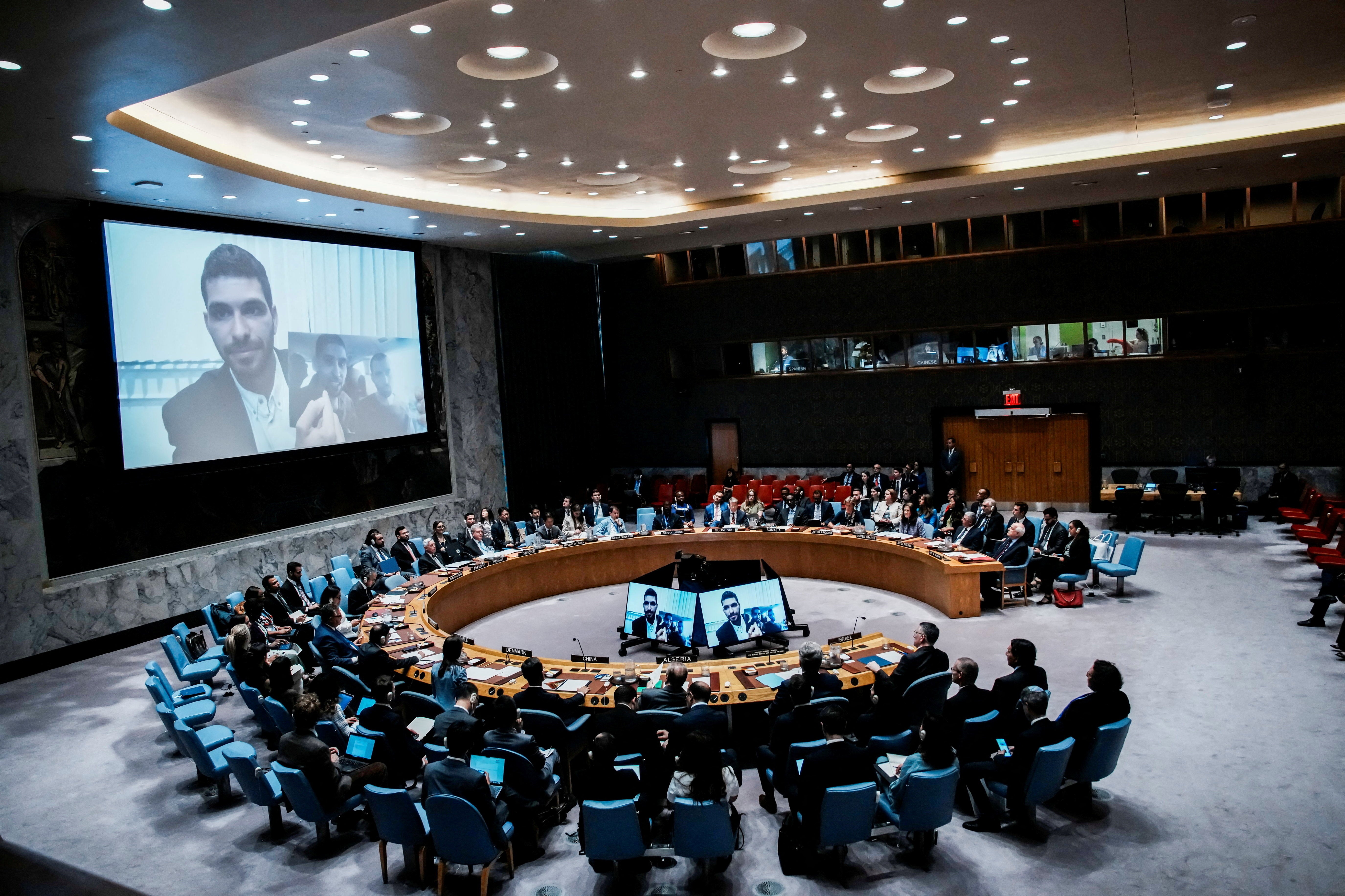 Ilay David on screen as he shows a picture of his brother Evyatar David, who is still in captivity, during a UN Security Council meeting