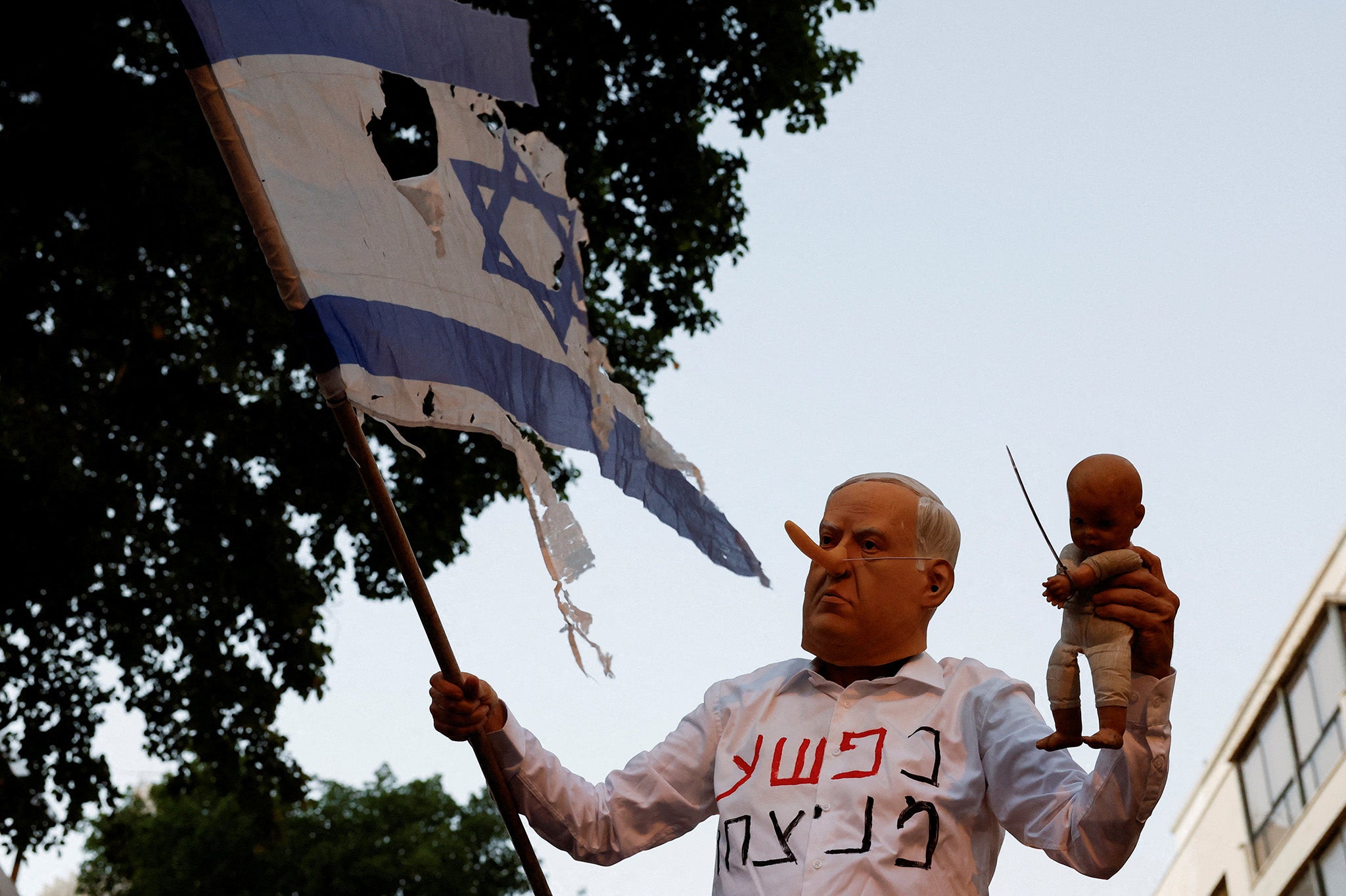 A demonstrator dressed up as Benjamin Netanyahu during a protest demanding the immediate release of hostages in Tel Aviv on Thursday