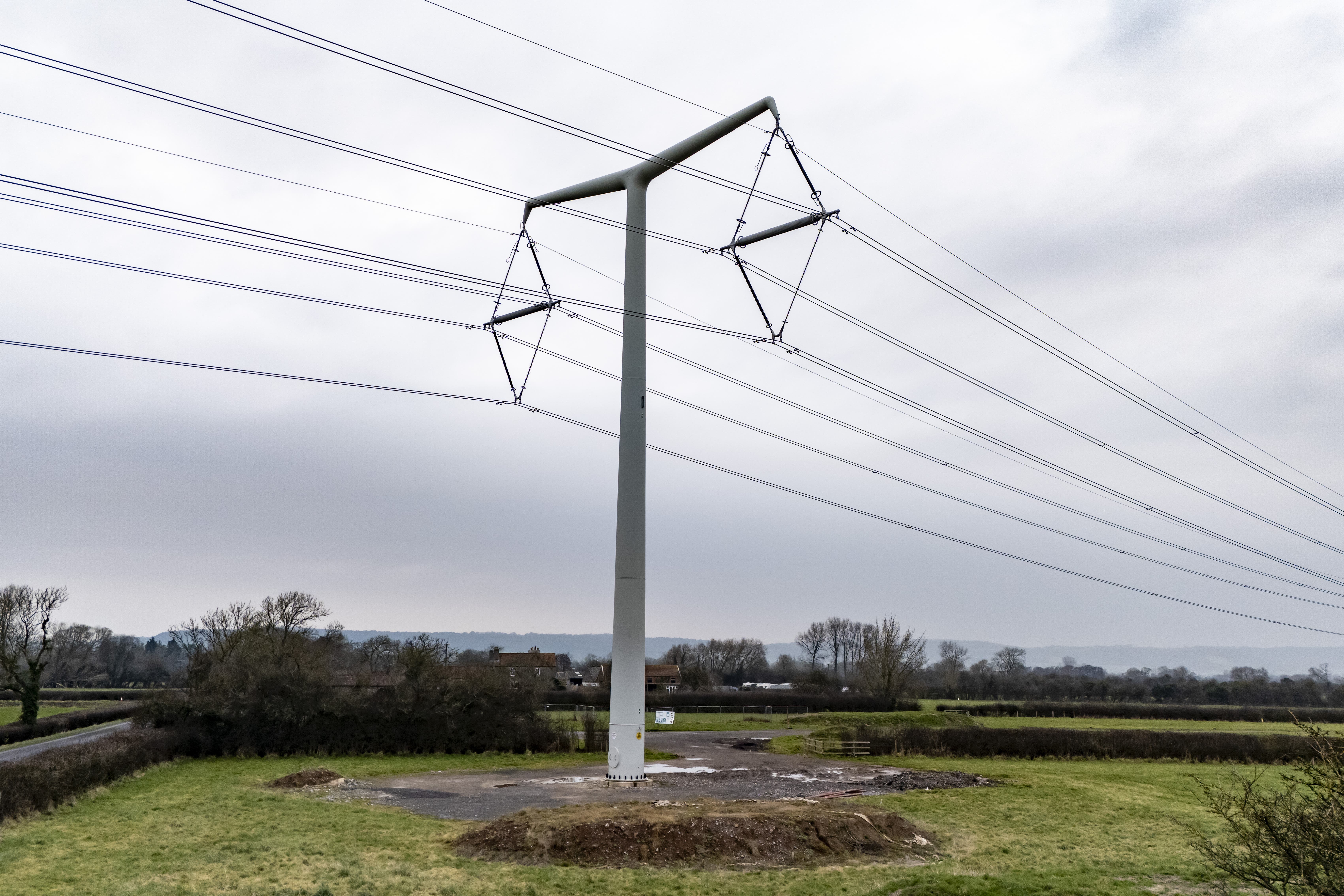 Infrastructure such as new ‘T’ style electricity pylons is needed to electrify Britain (Ben Birchall/PA)