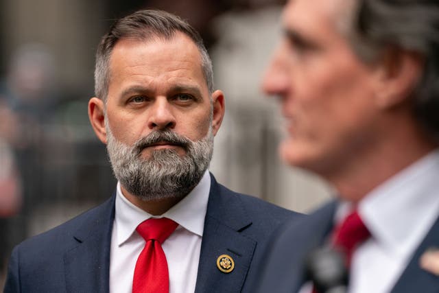 <p>Cory Mills looks on at a press conference. He's being accused by Miss United States of sextortion, which he denies</p>