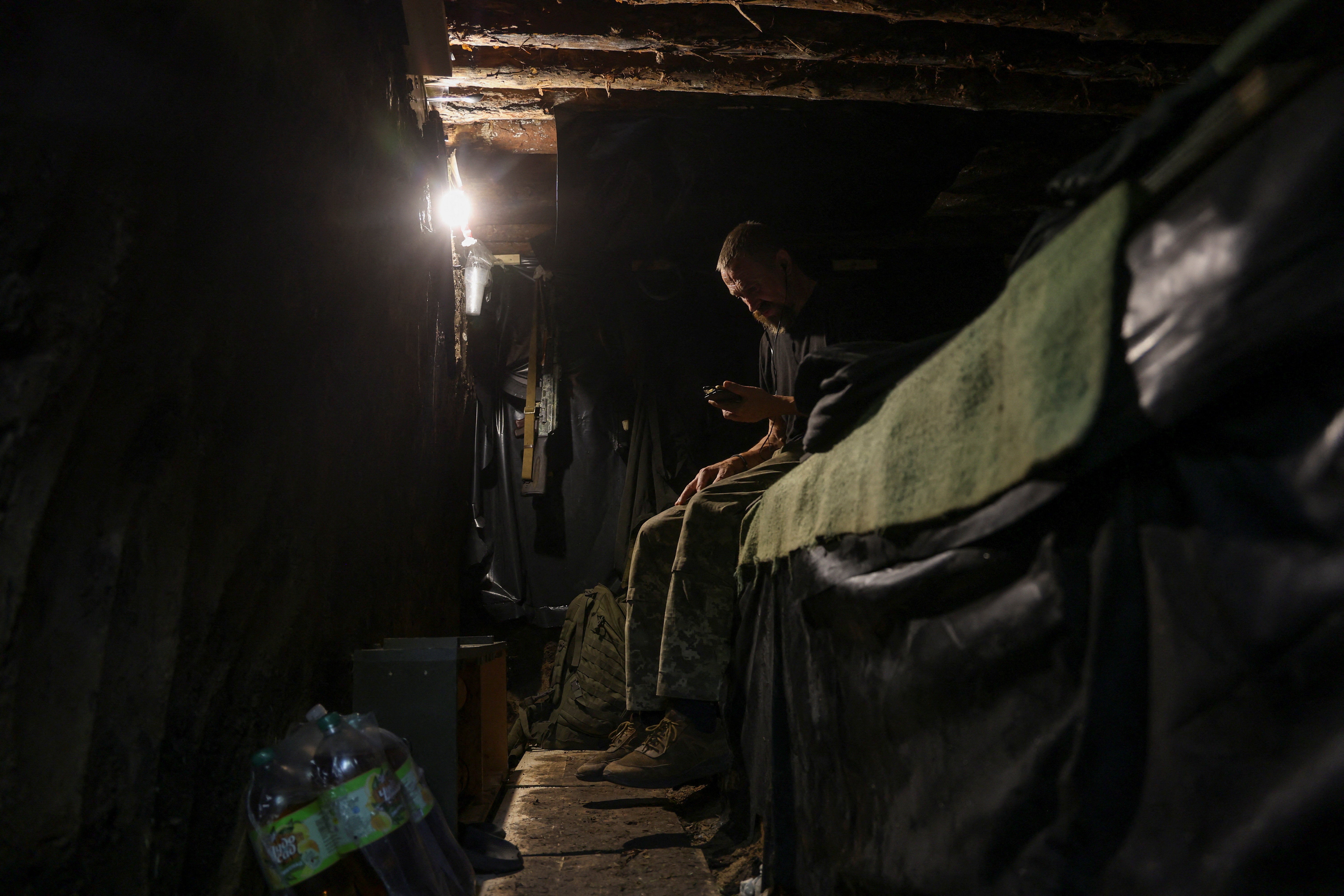 Ukrainian Armed Forces rests inside a dugout at a position in a front line, amid Russia's attack on Ukraine, in Donetsk region