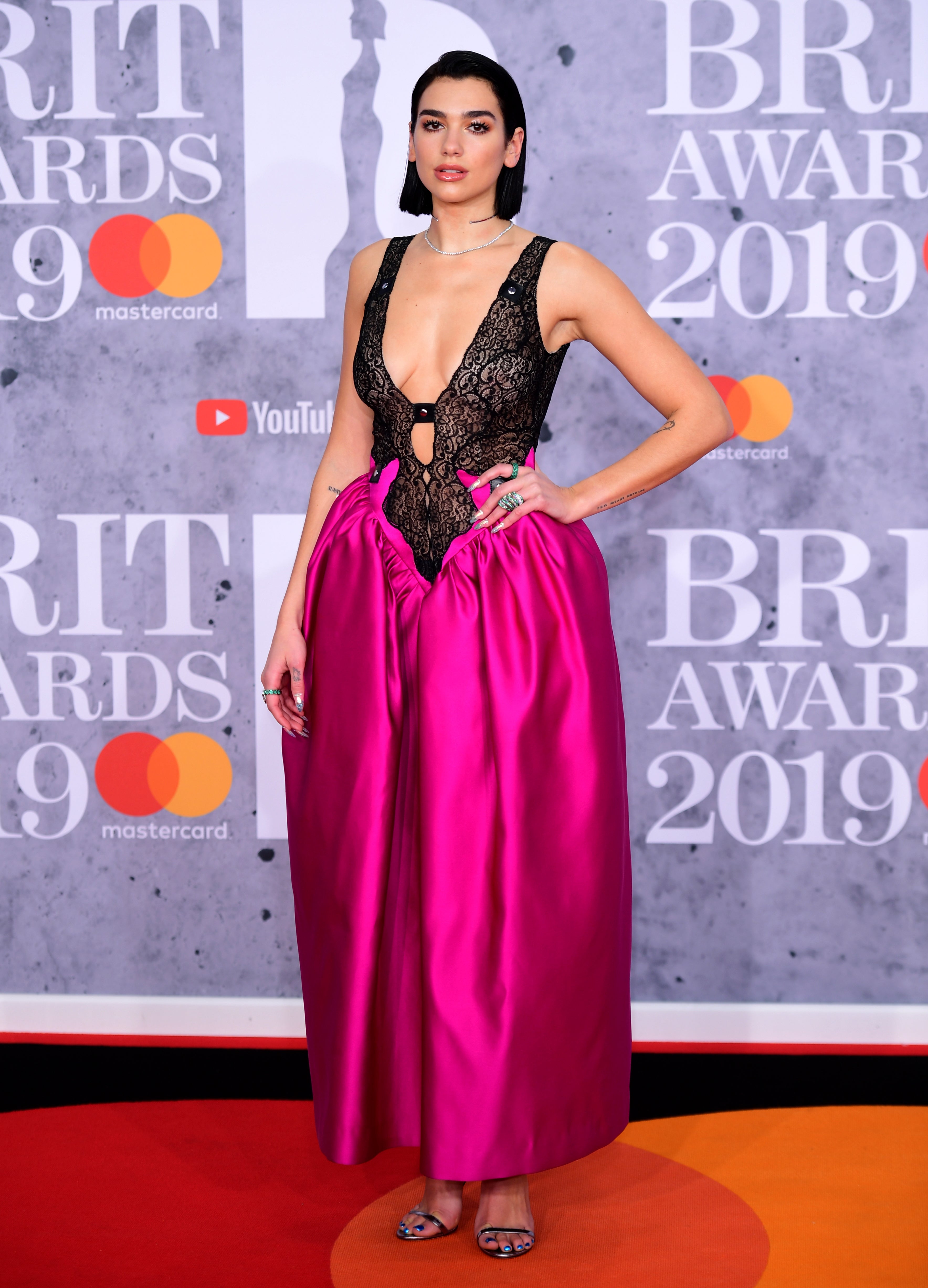 Dua Lipa wore a fuchsia and black drop waist dress to the 2019 Brit Awards