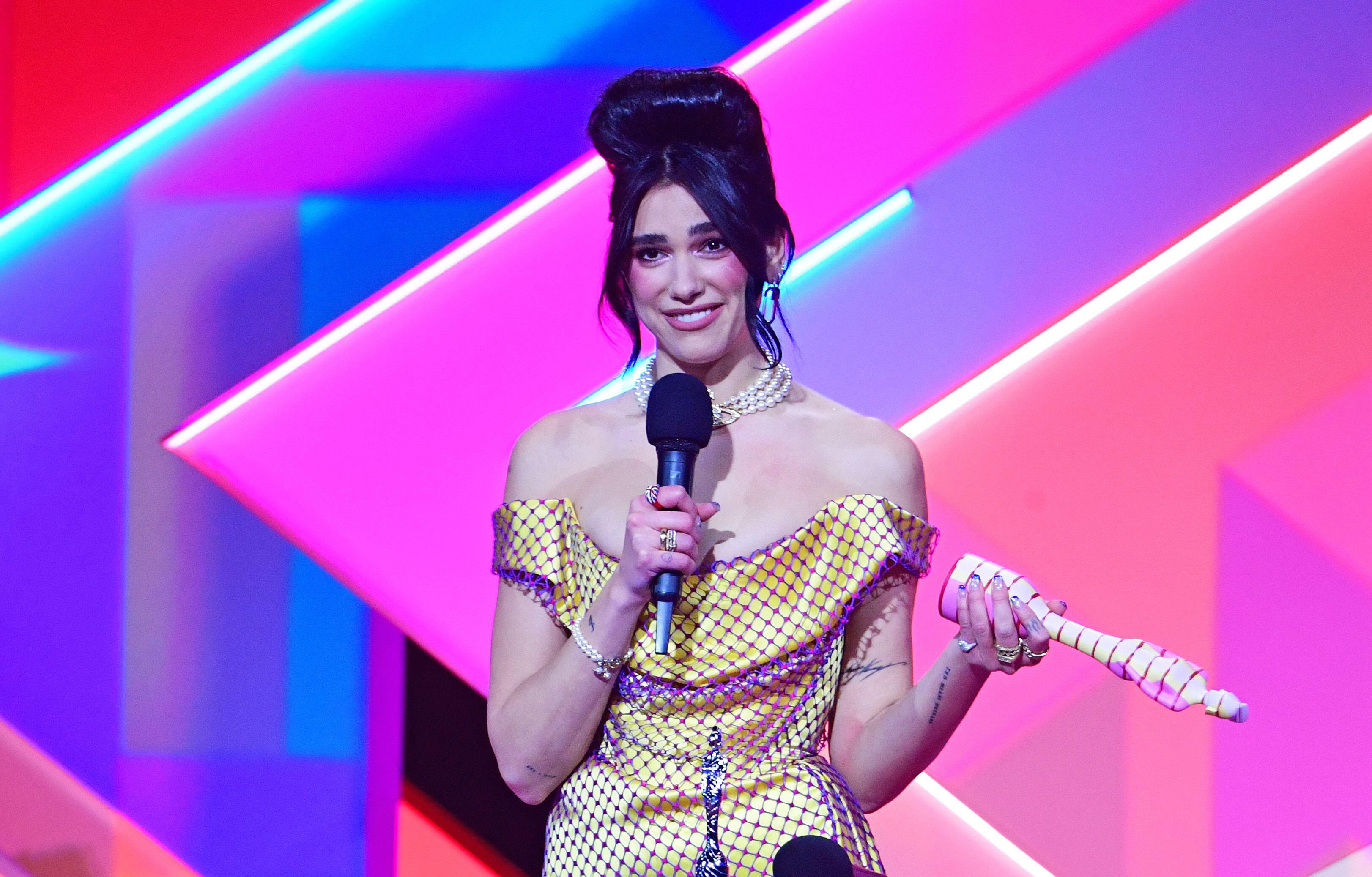 Lipa for a yellow Vivienne Westwood gown to accept the award for Best Album at the 2021 Brits
