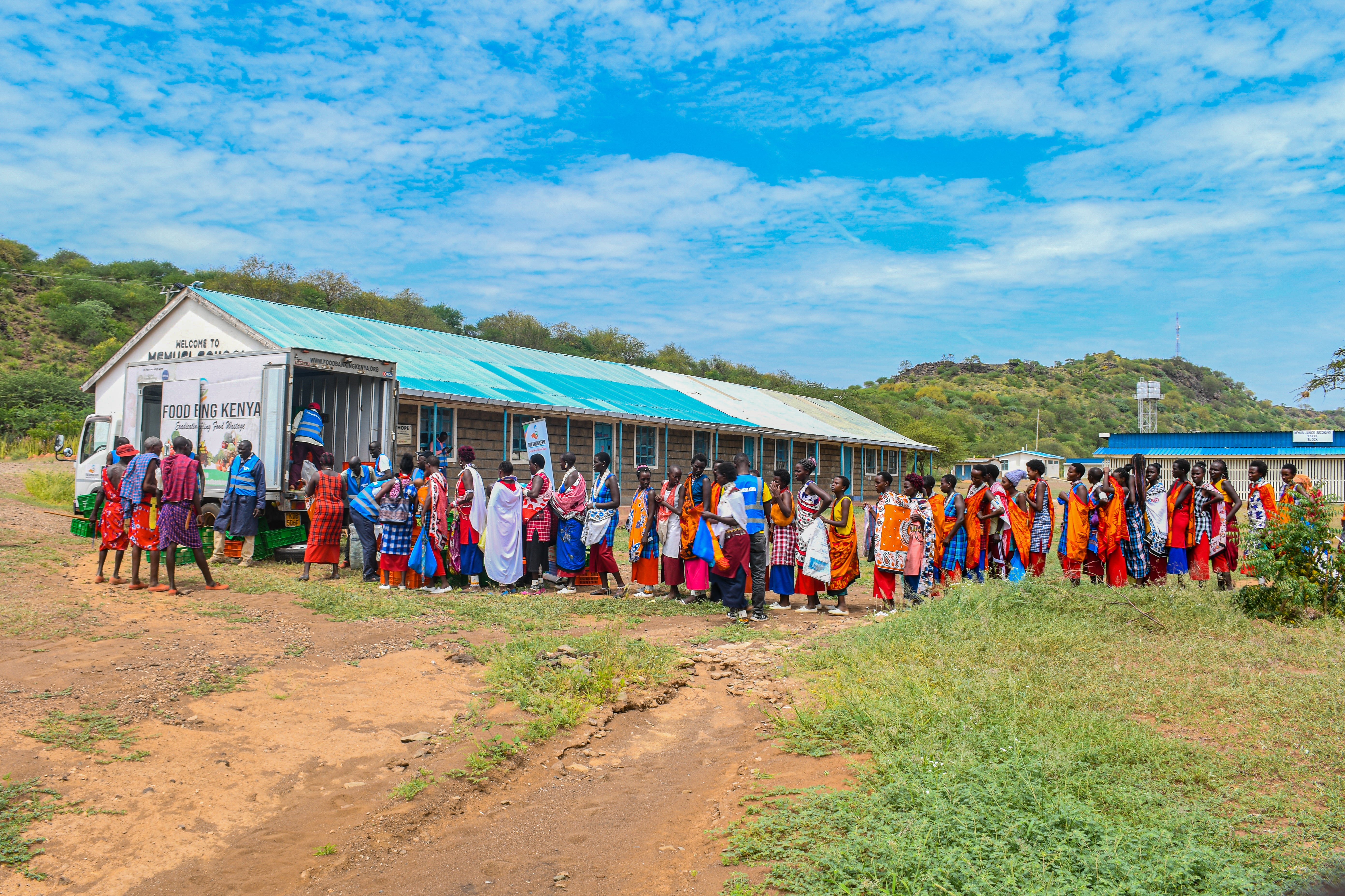 Villagers queue for food at a pop-up run by Food Banking Kenya