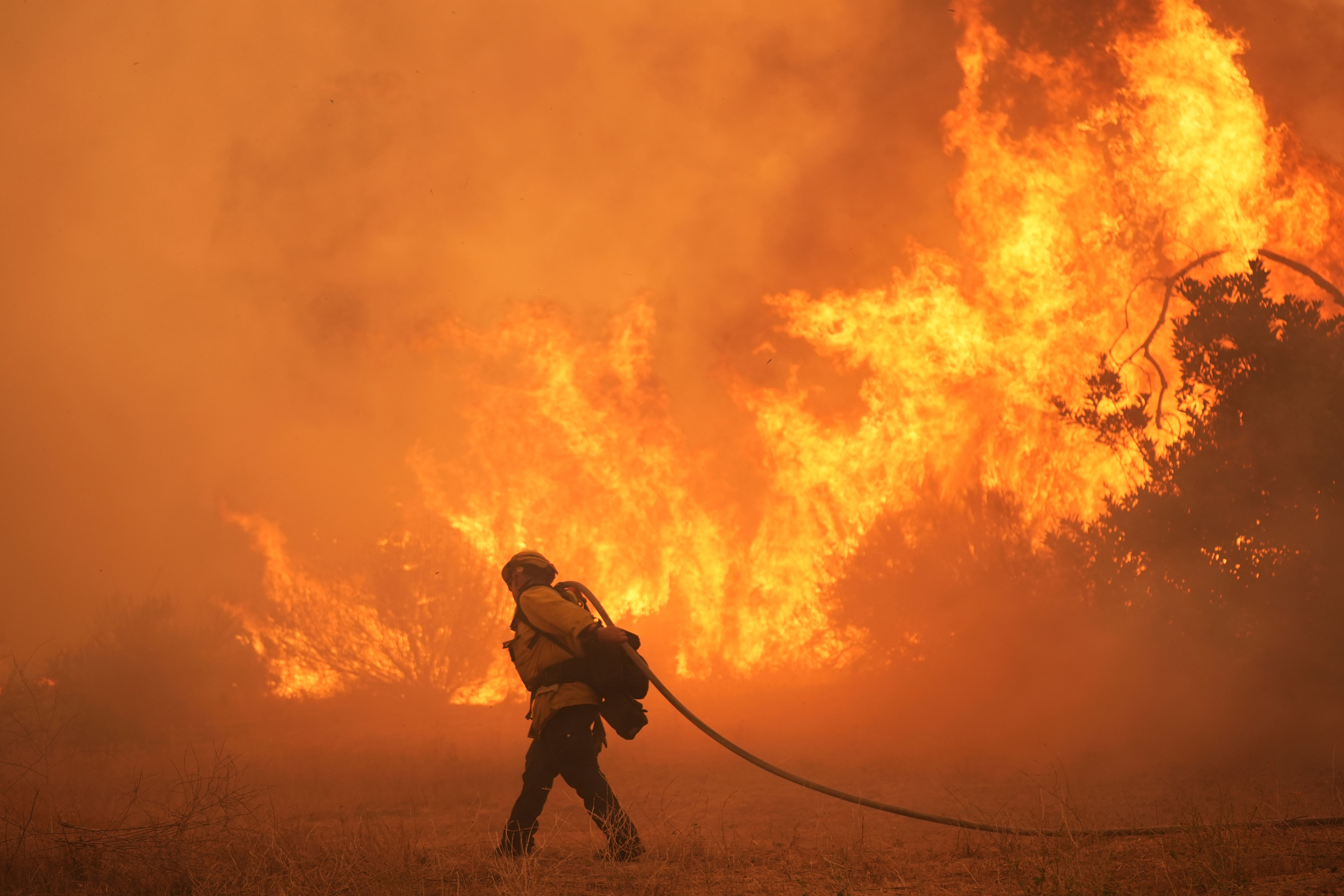 A firefighter battles the flames of the Canyon Fire, which broke out Thursday afternoon and was spreading quickly.