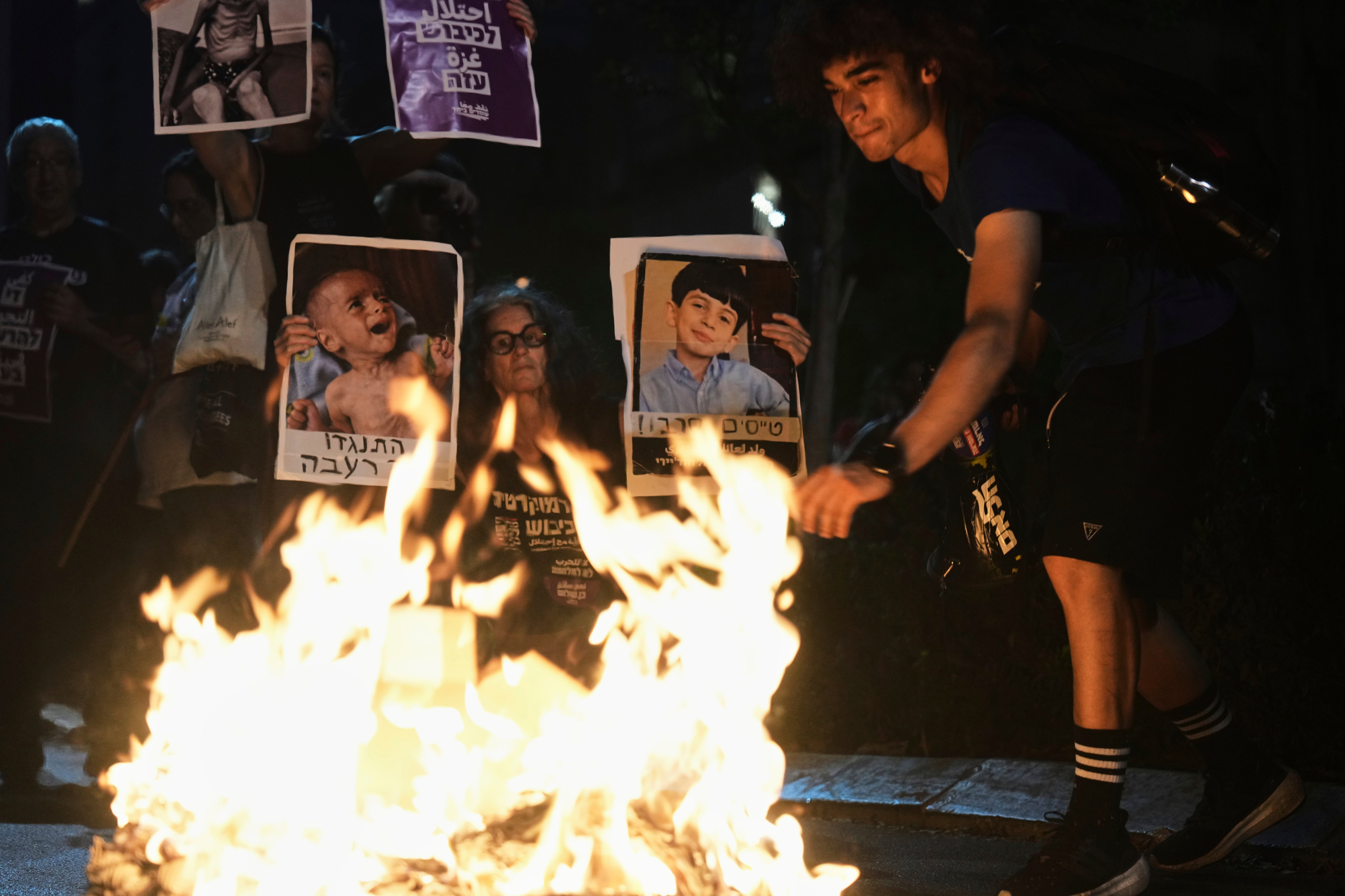 Israeli activists protest against the war in the Gaza Strip, Israel's measures regarding food distribution and the forced displacement, in Tel Aviv, Israel, Thursday, Aug. 7, 2025