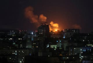An explosion of a drone lights up the sky over the city during a Russian drone strike in Kyiv