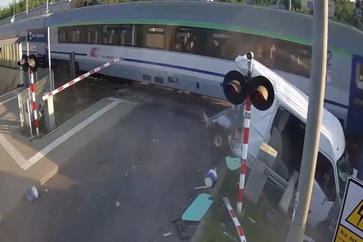 Train slams into van at level crossing after driver runs red light