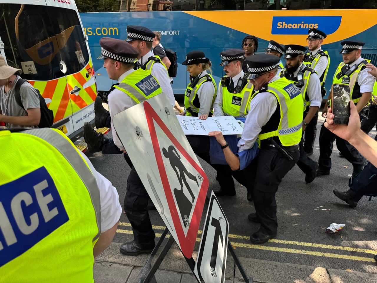 A guard is overcome after protesting against the use of terrorist laws to ban Palestine's action