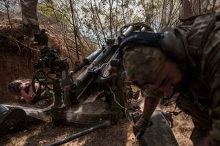 Ukrainian servicemen of the 148th artillery brigade fire from a M777 howitzer towards Russian positions at the frontline in Zaporizhzhia region on Thursday
