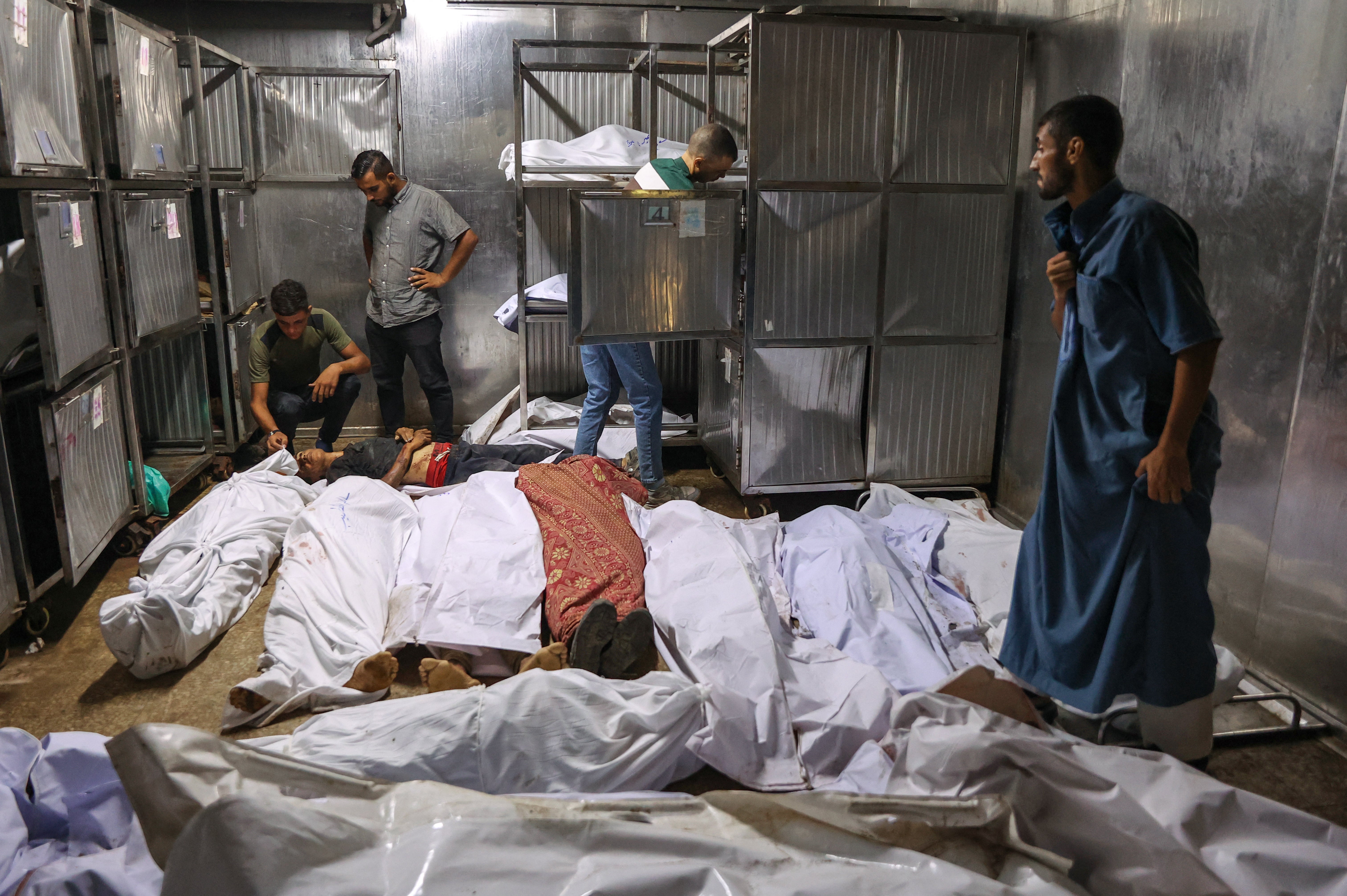 Palestinians condole the surprised bodies on the previous day, seeking assistance near Zikim, in the northern Gaza Strip of Al-Shifa Hospital in Gaza city on August 10, 2025.