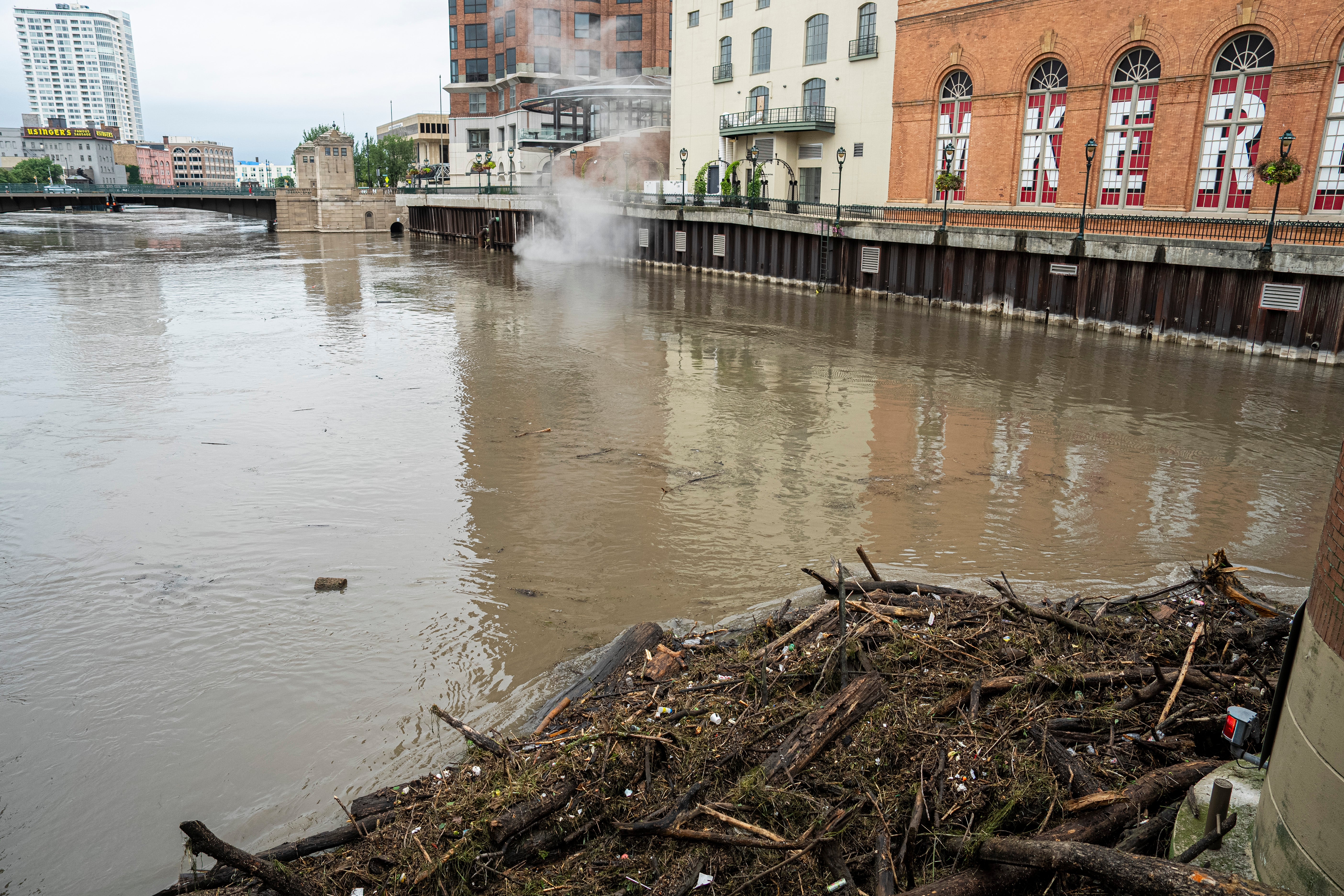 Debris from flash flooding piles up near a bridge in Milwaukee. Some areas of the city saw more than 14 inches of total rainfall as of Sunday morning