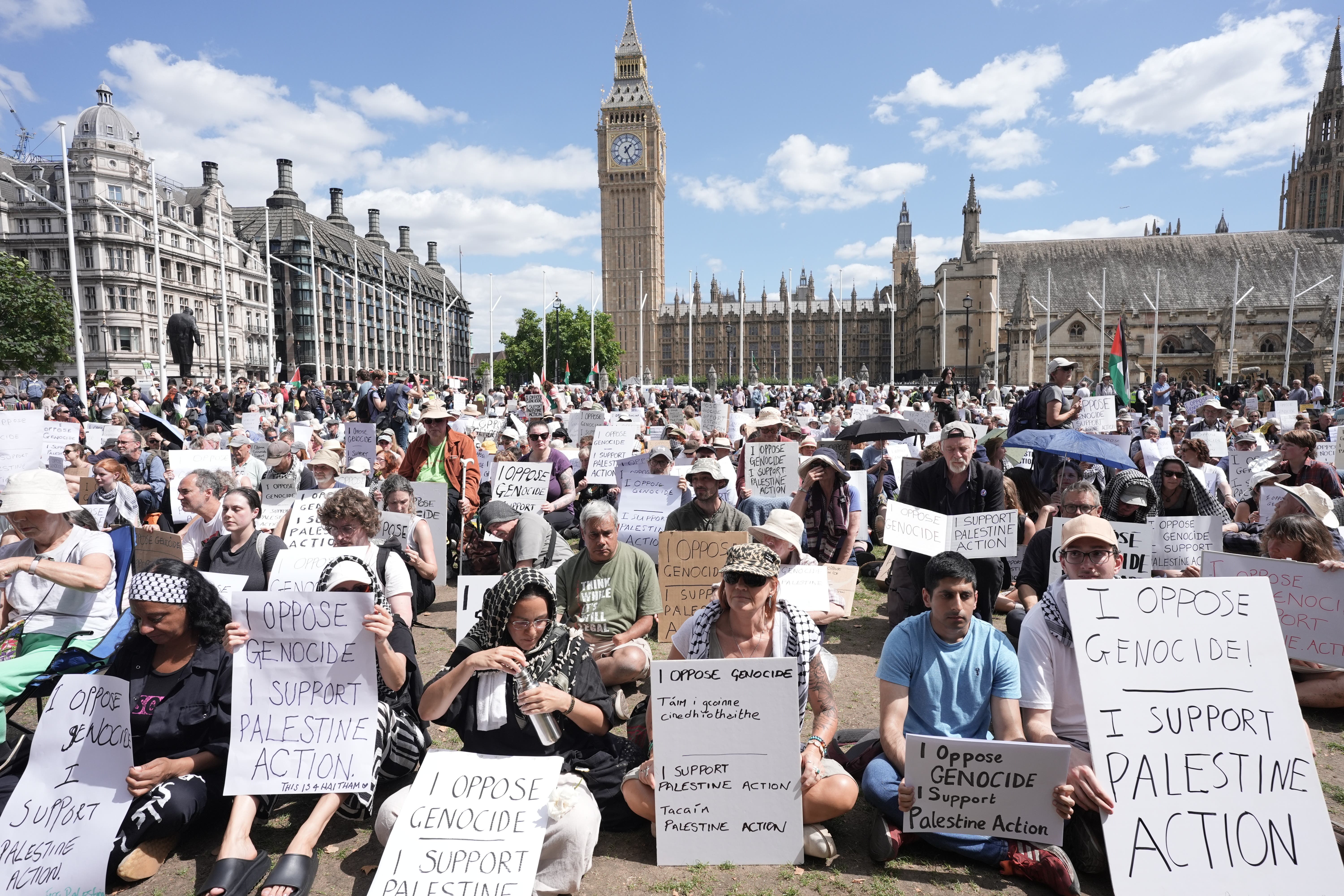 Protesters sat on the grass in Parliament Square during Saturday’s demonstration (Stefan Rousseau/PA)