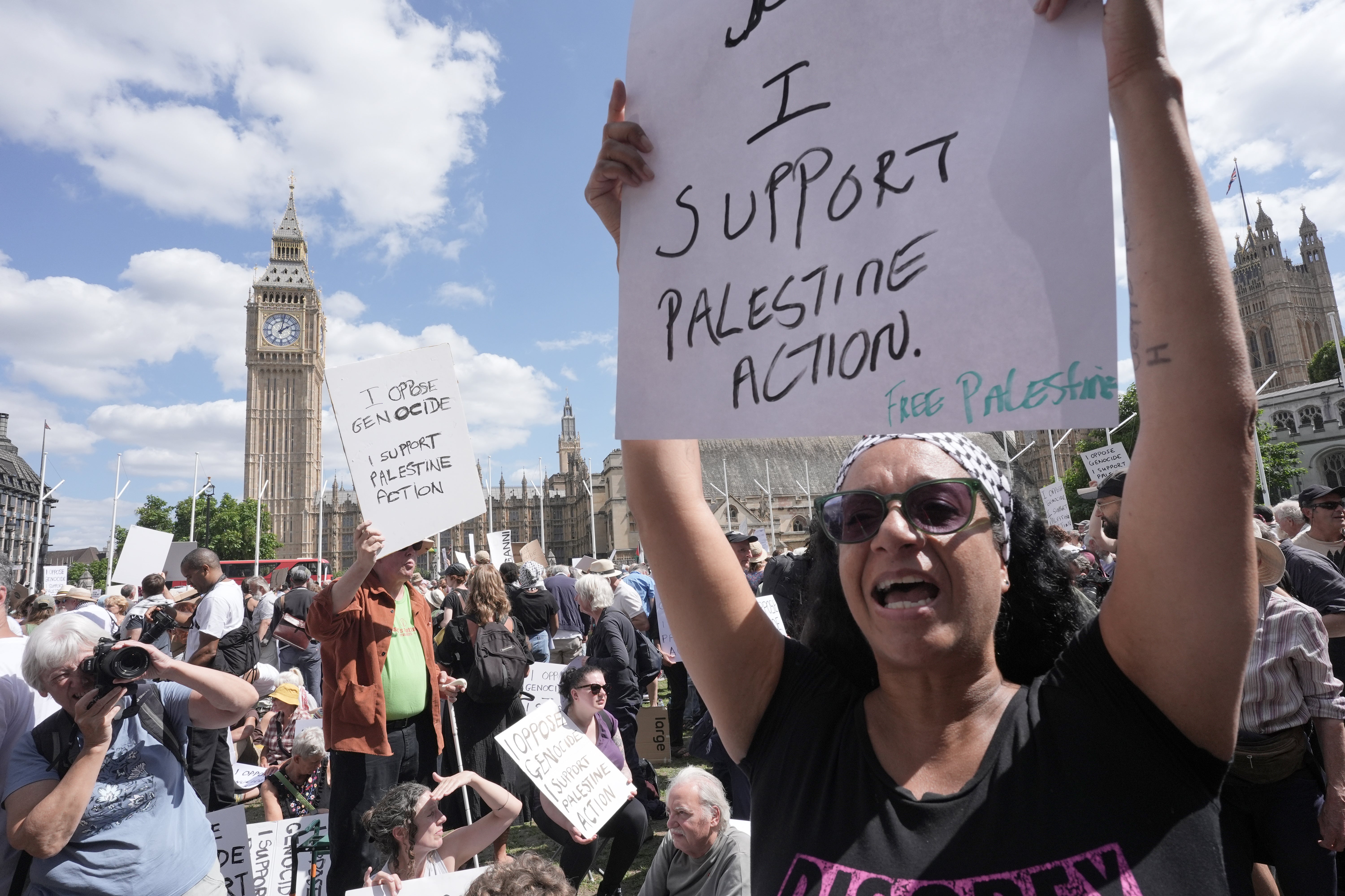 Plancards read: 'I oppose the massacre, I support Palestine Action'