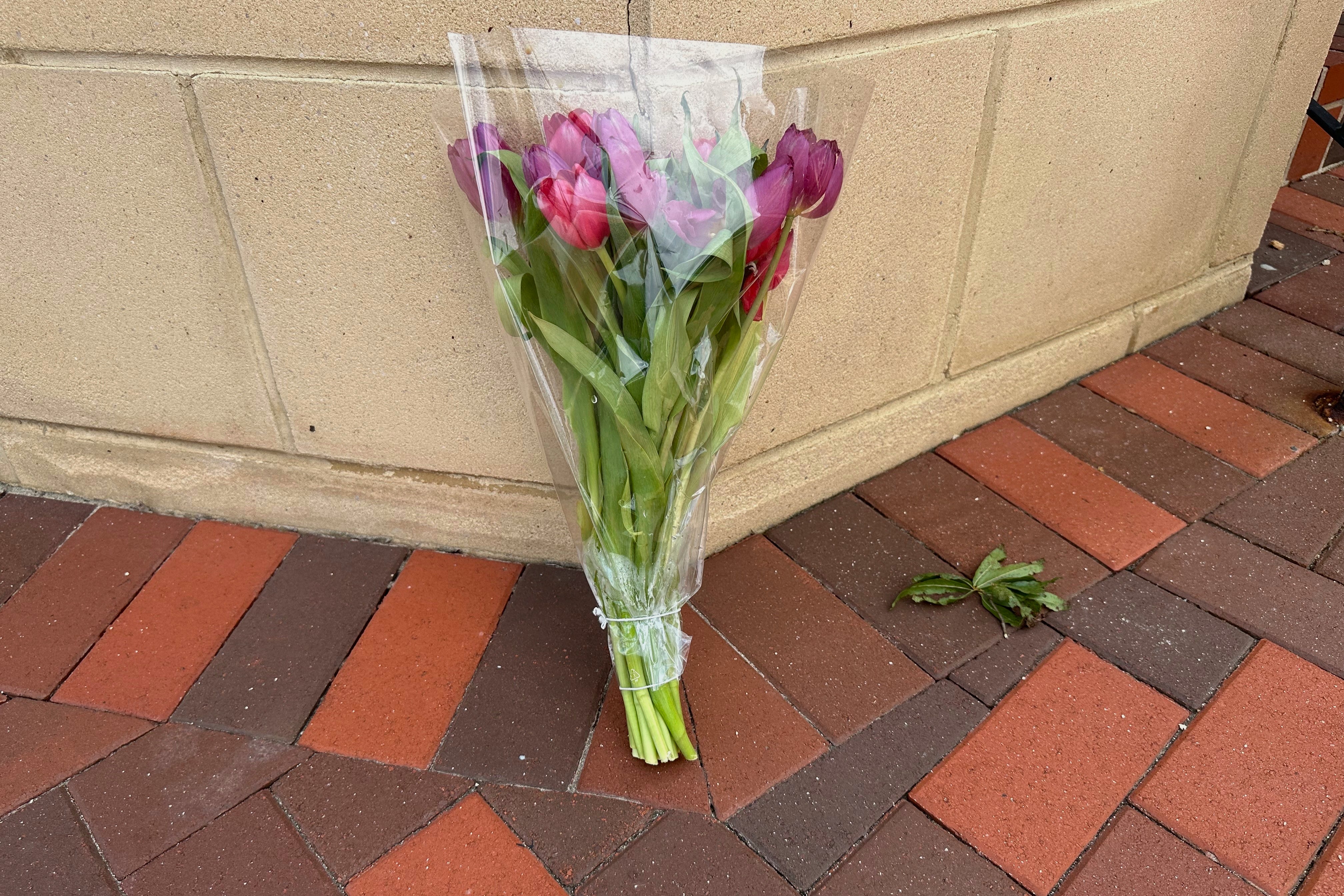 A bouquet sits outside the CVS where police say a gunman killed a police officer and fired several rounds at the CDC campus
