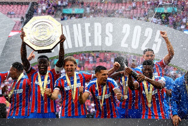 <p>Marc Guehi lifts the Community Shield aloft after victory at Wembley</p>
